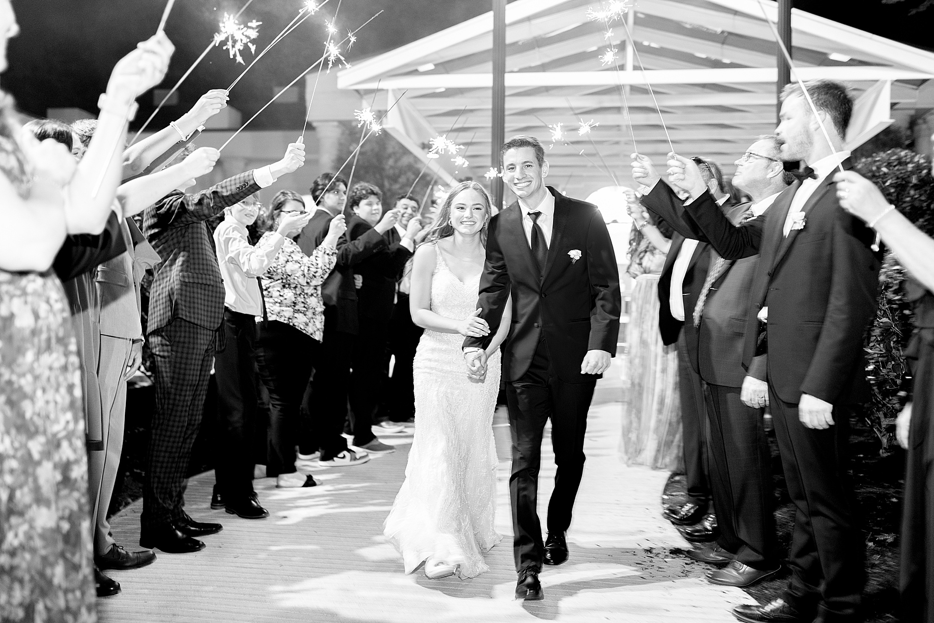 newlyweds exit wedding as guests hold sparklers 