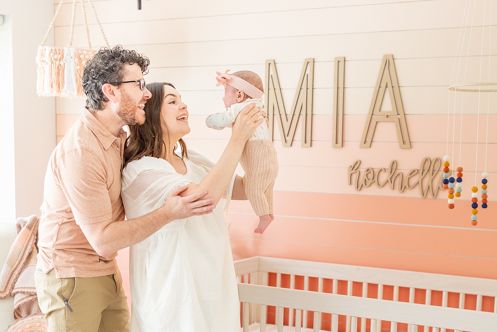 loving parents hold up their newborn