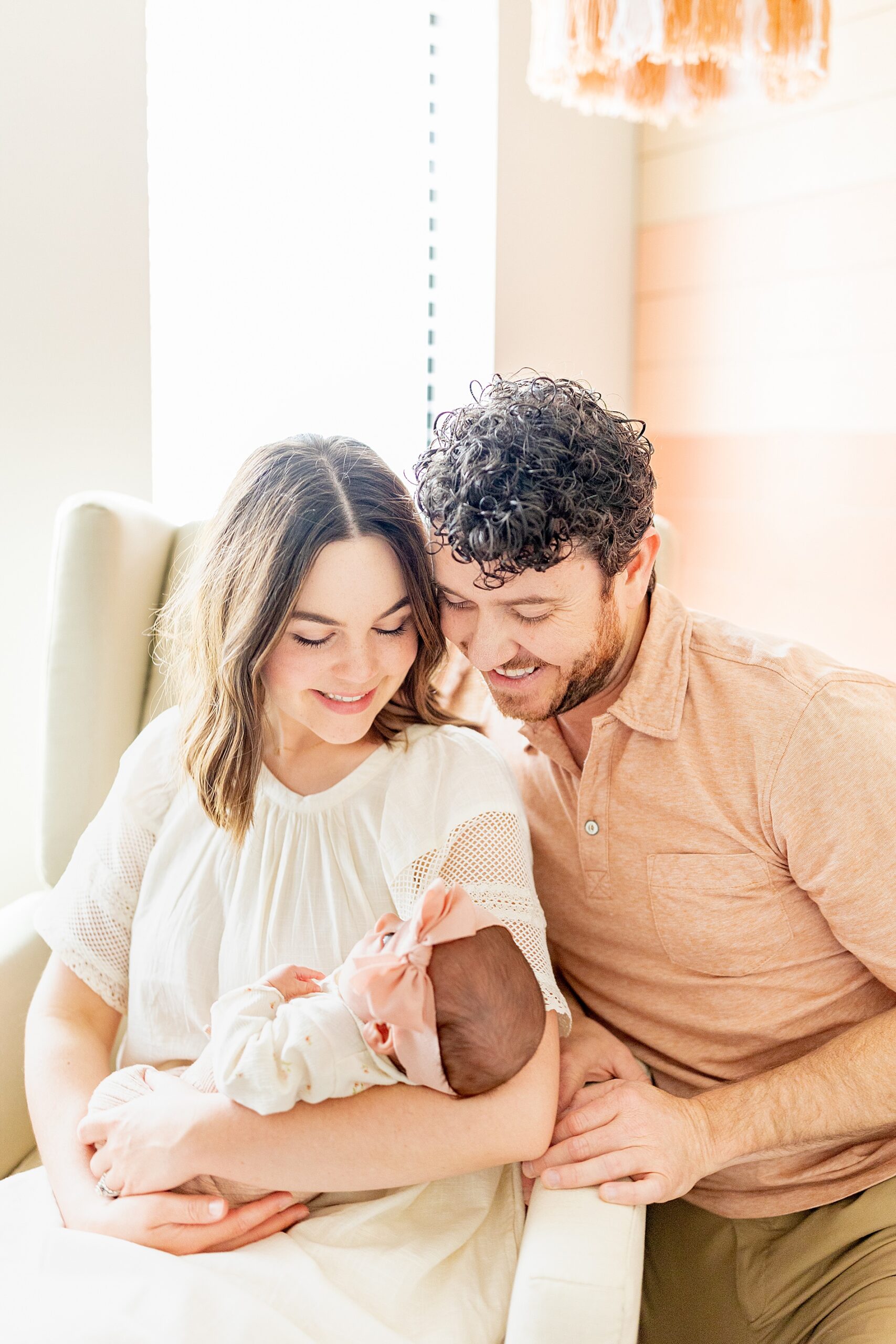 new parents look lovingly at newborn 