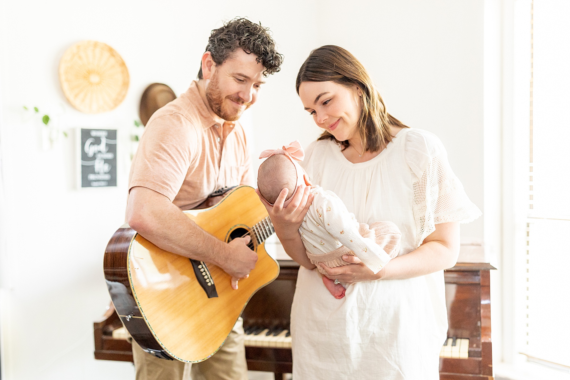 dad plays guitar during newborn session