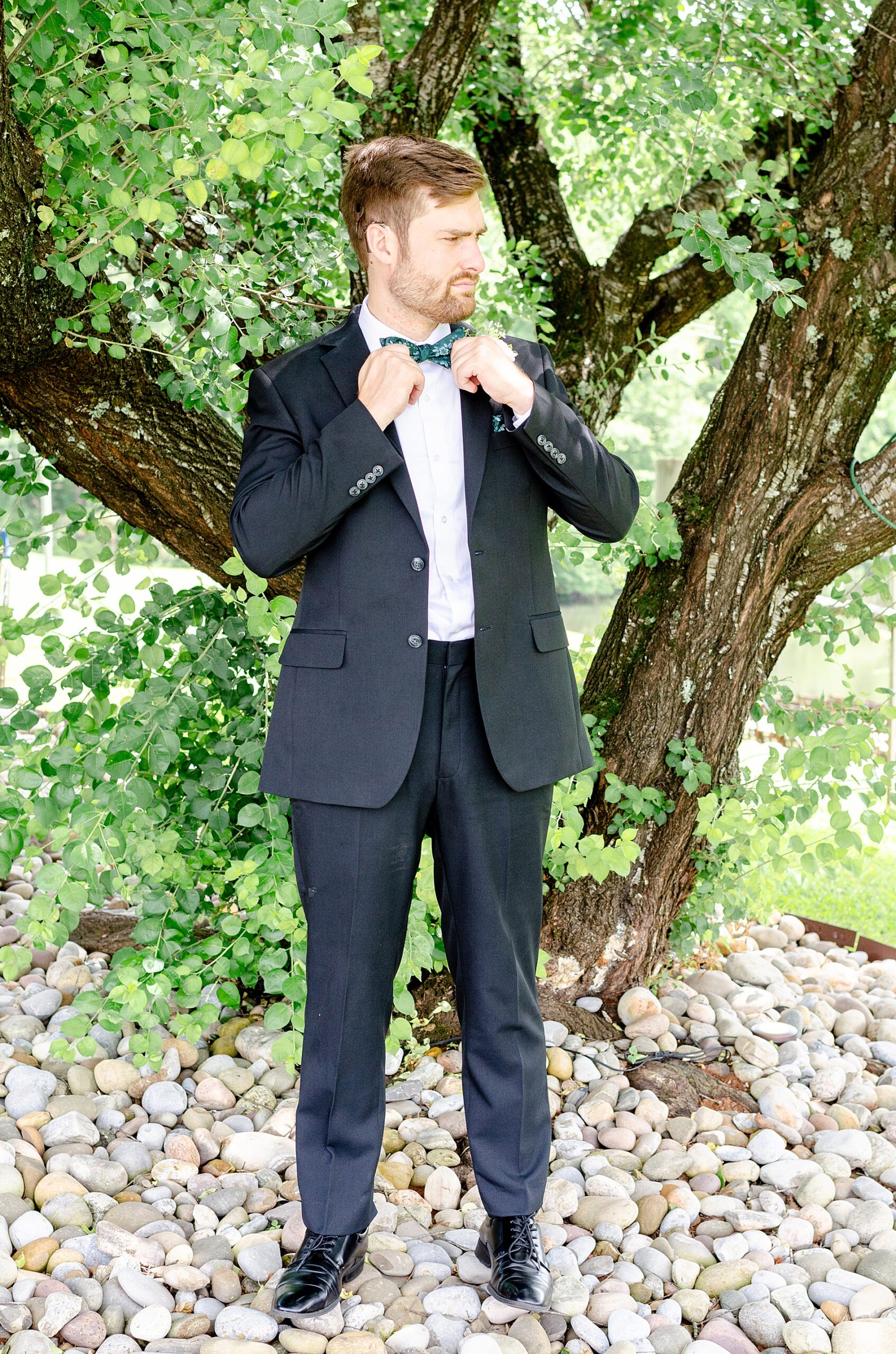 groom stands outside 