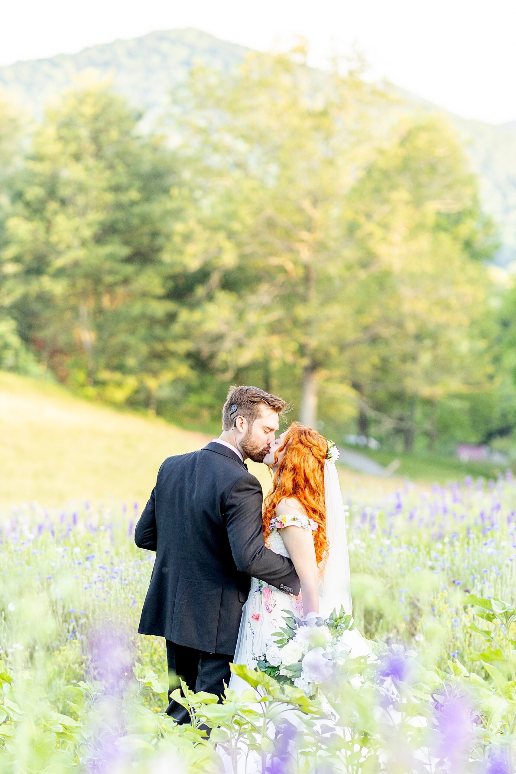 bride and groom kiss in field of flowers  at The Never Ending Flower Farm in Asheville, NC