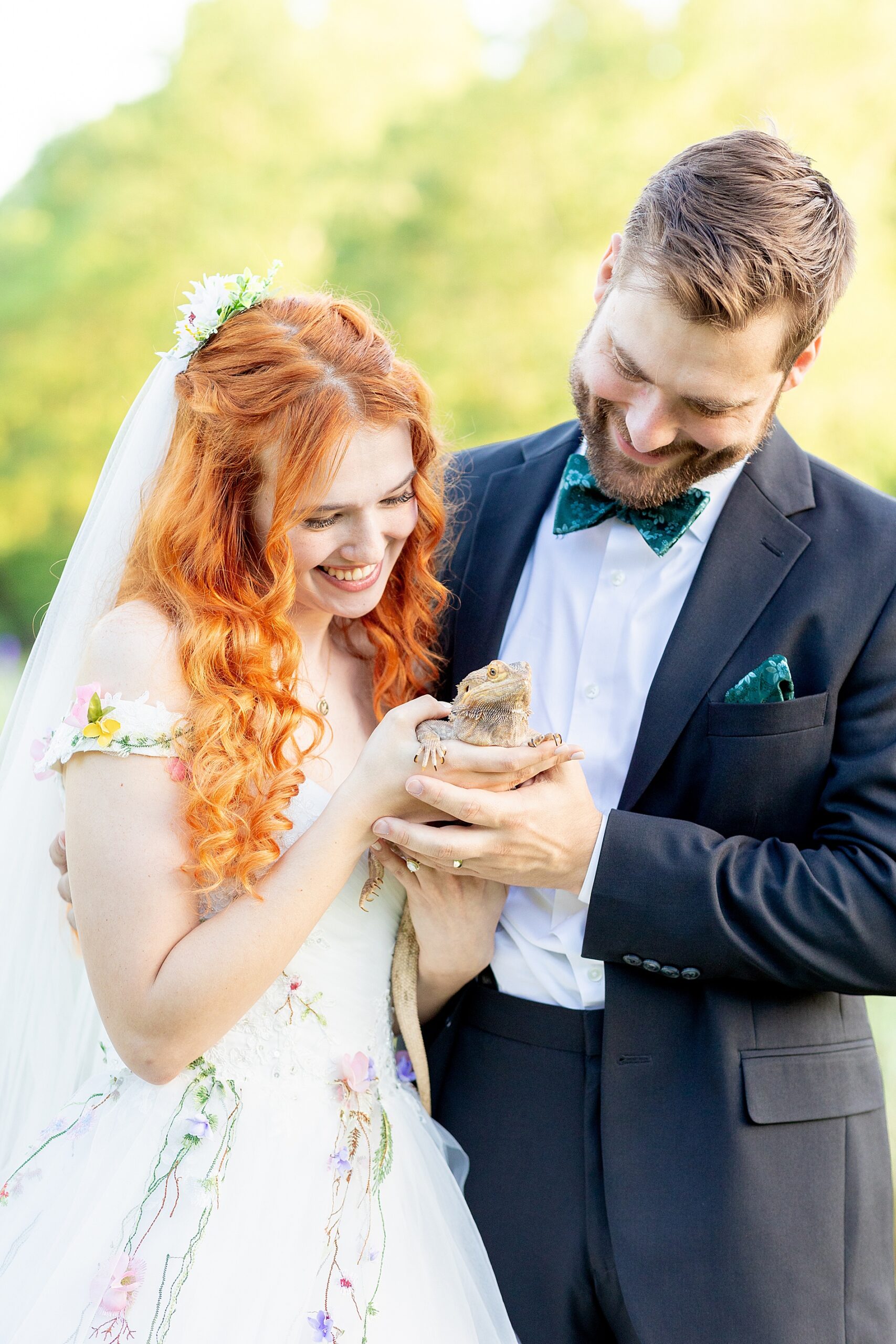 couple look down at their pet dragon