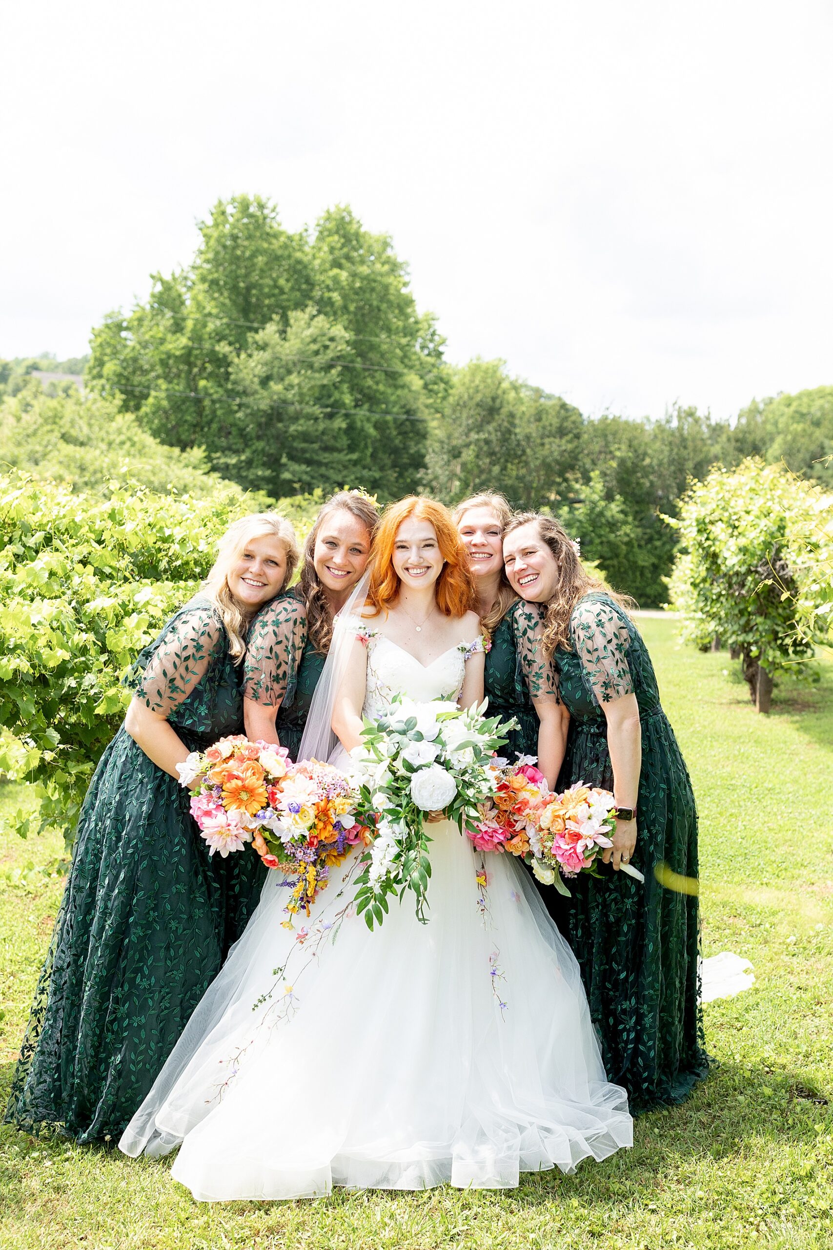 bride with bridesmaids in green dresses