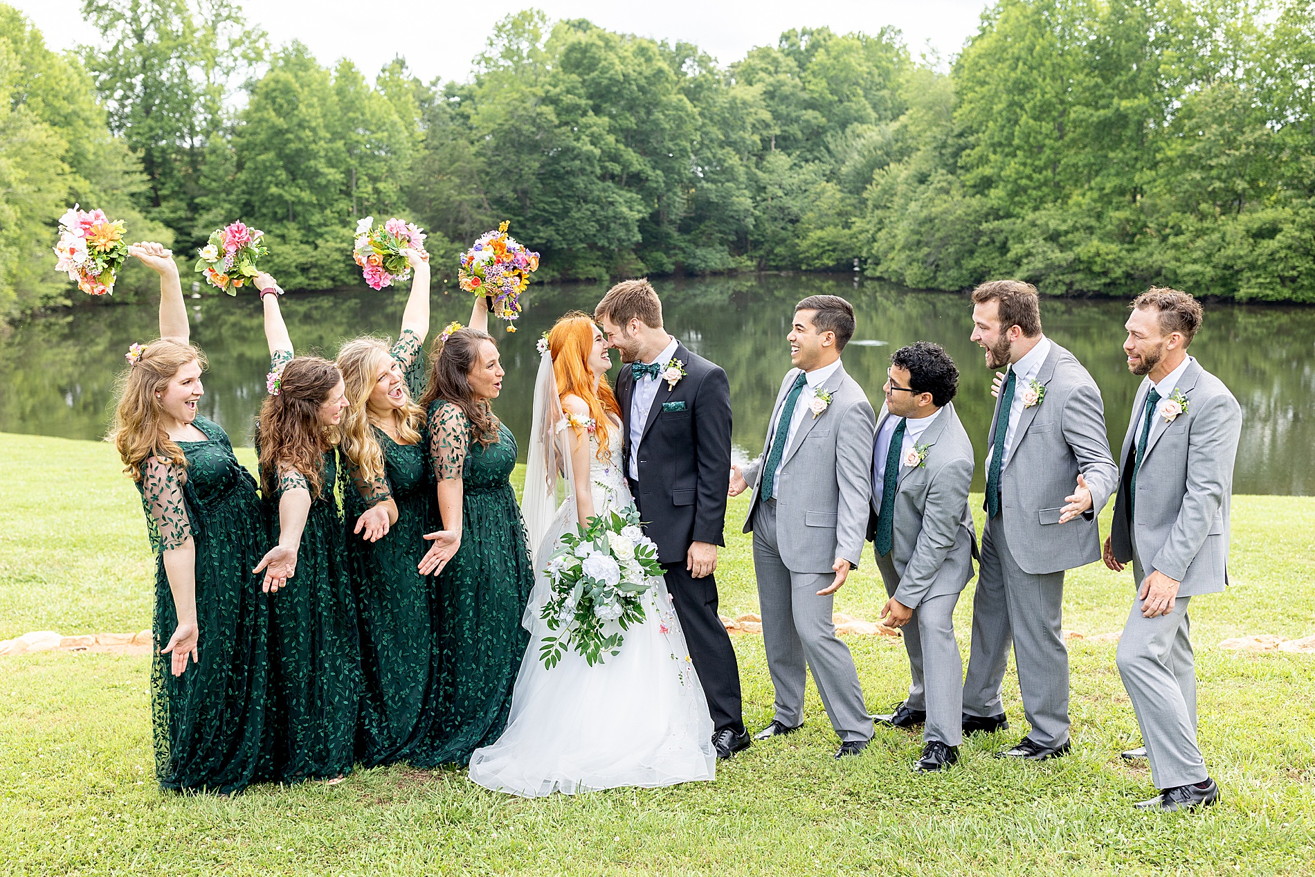 bride and groom kiss as bridal party cheers 