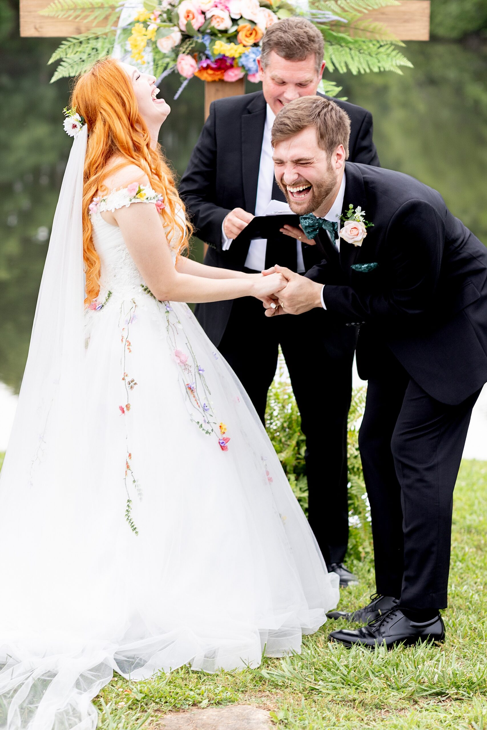 bride and groom laugh during wedding ceremony 