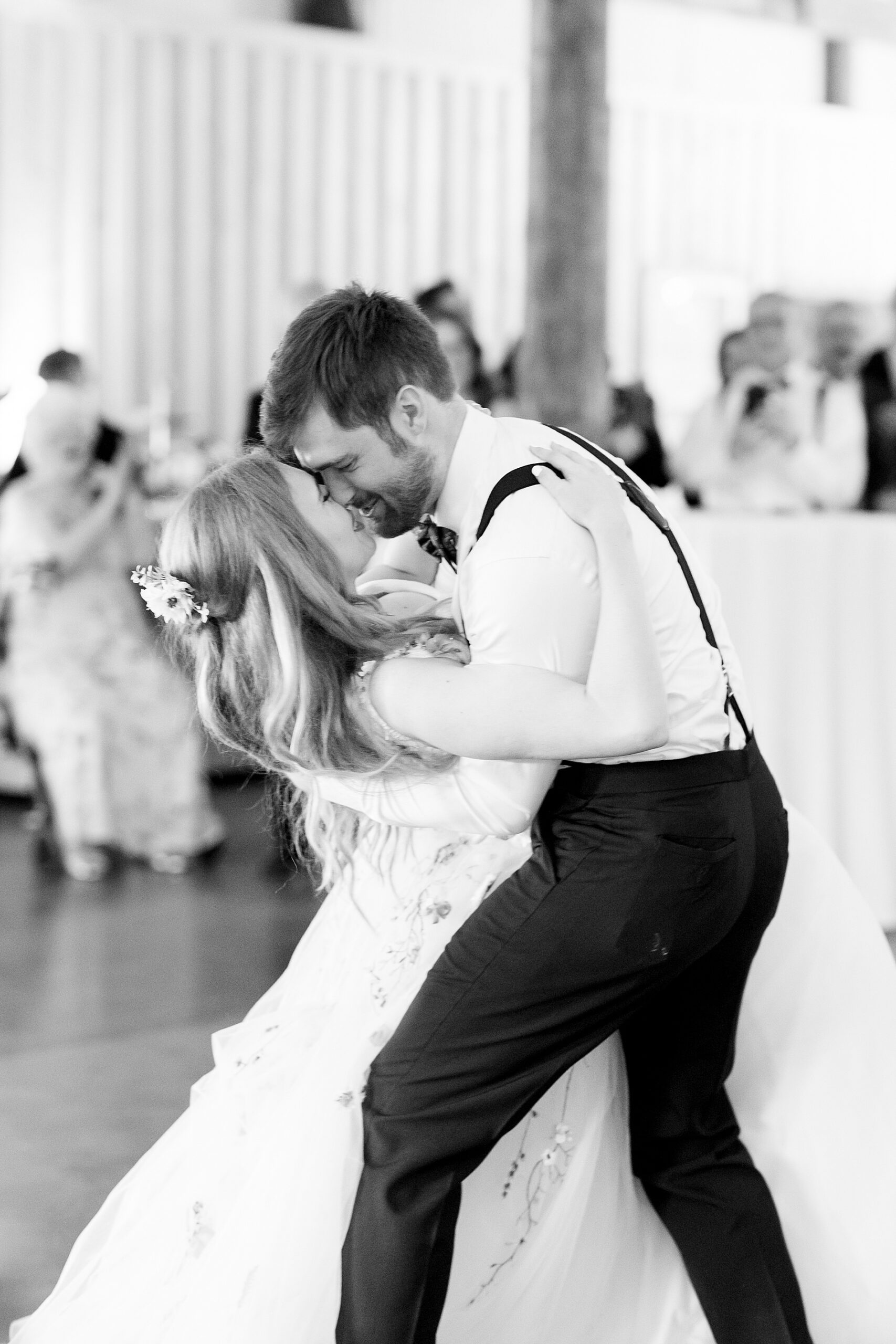 groom dips his bride on the dance floor