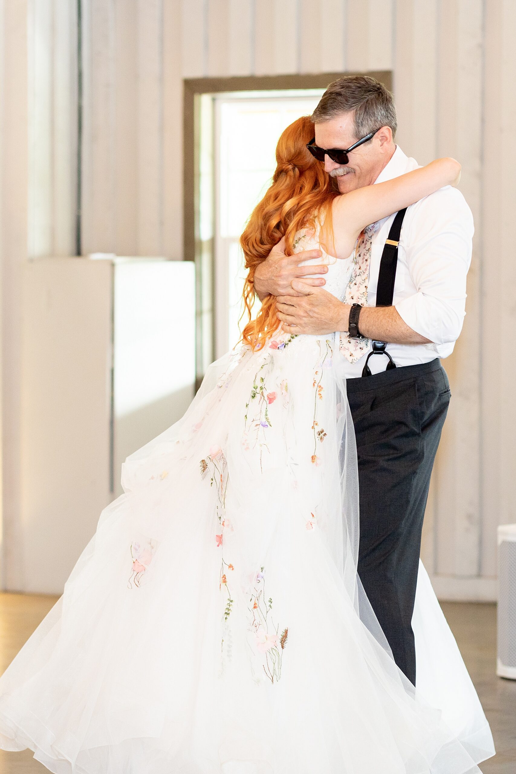 bride hugs her dad after dance