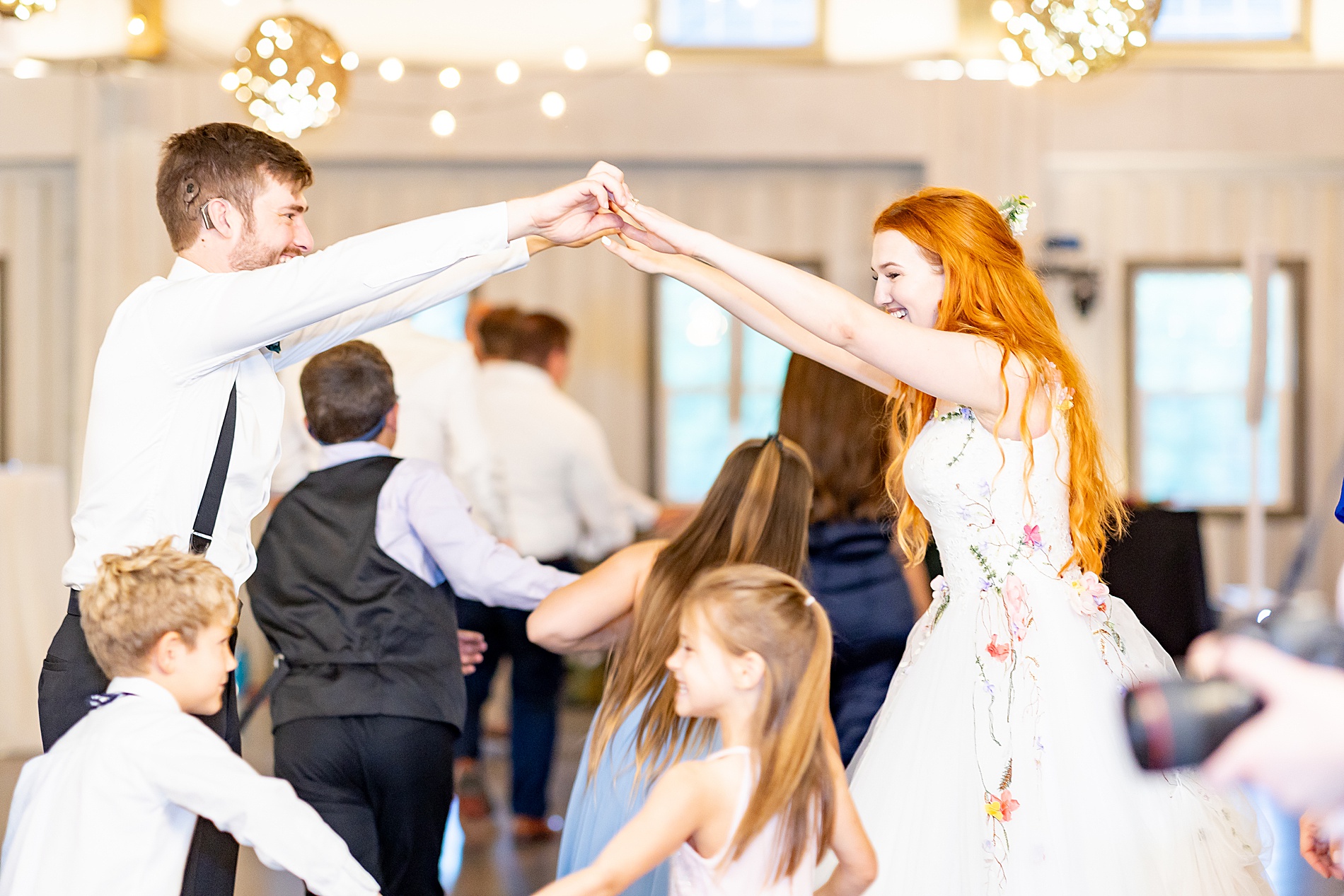 bride and groom dancing with guests