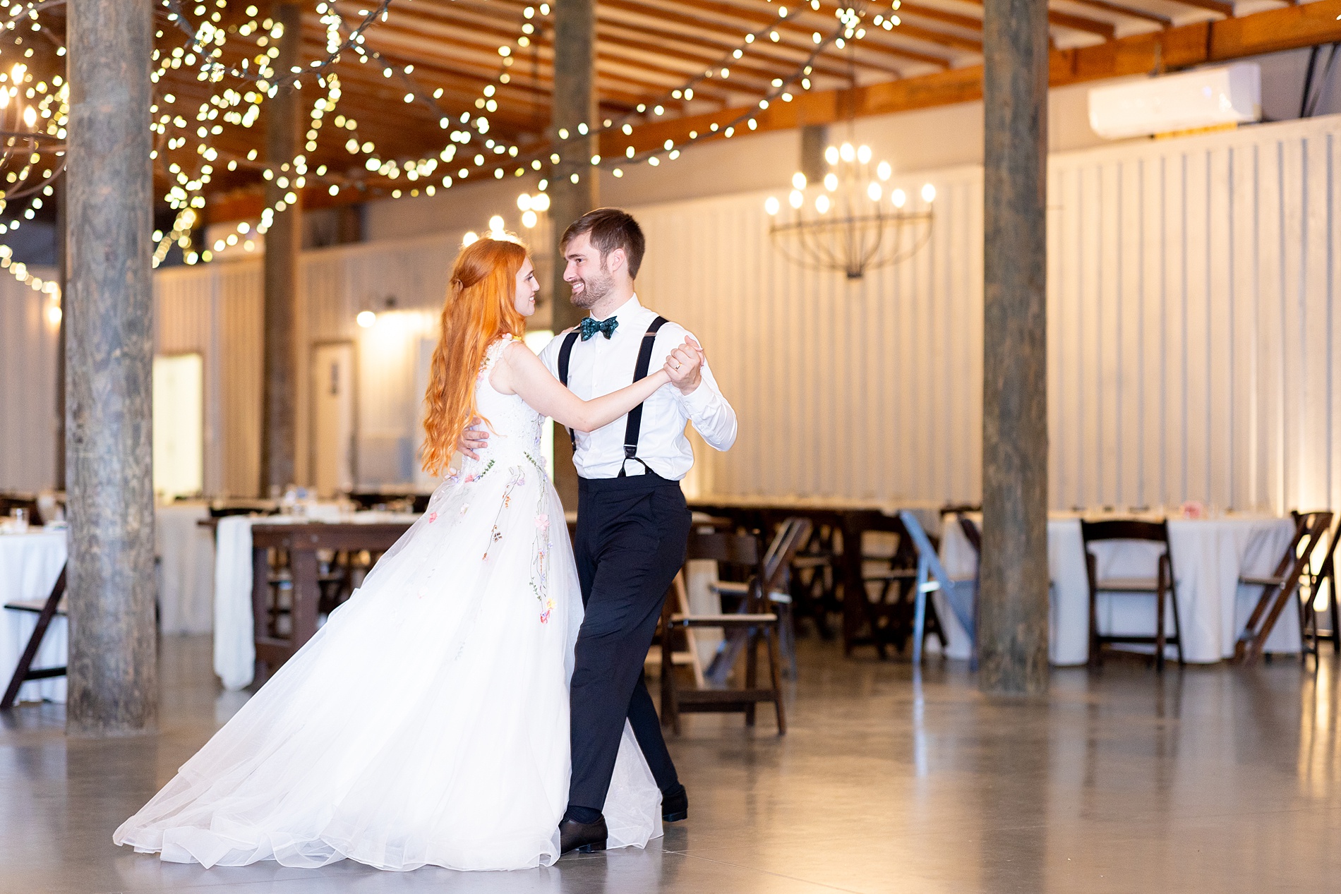 bride and groom dance together at the end of wedding night