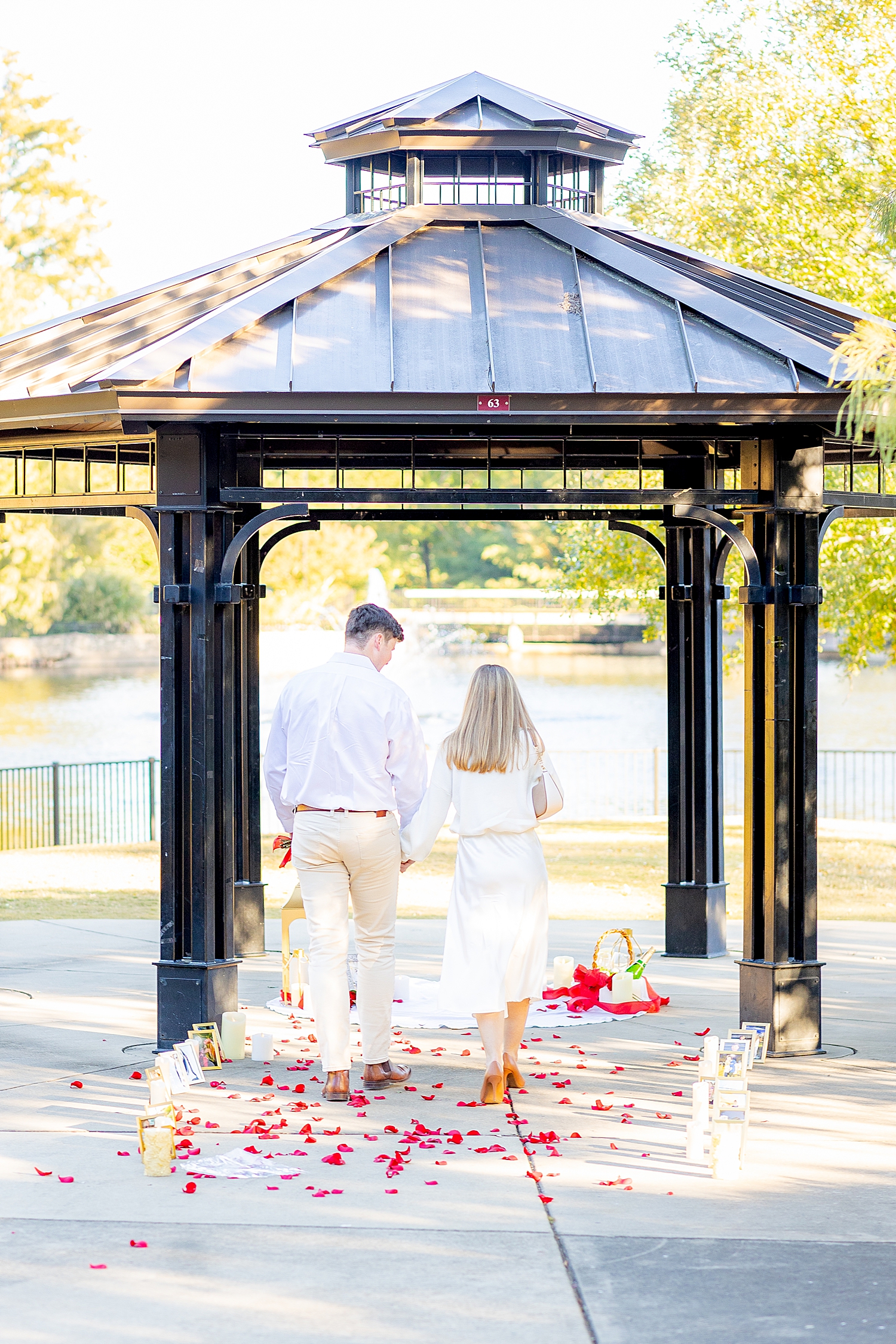 couple walk together up path for proposal 