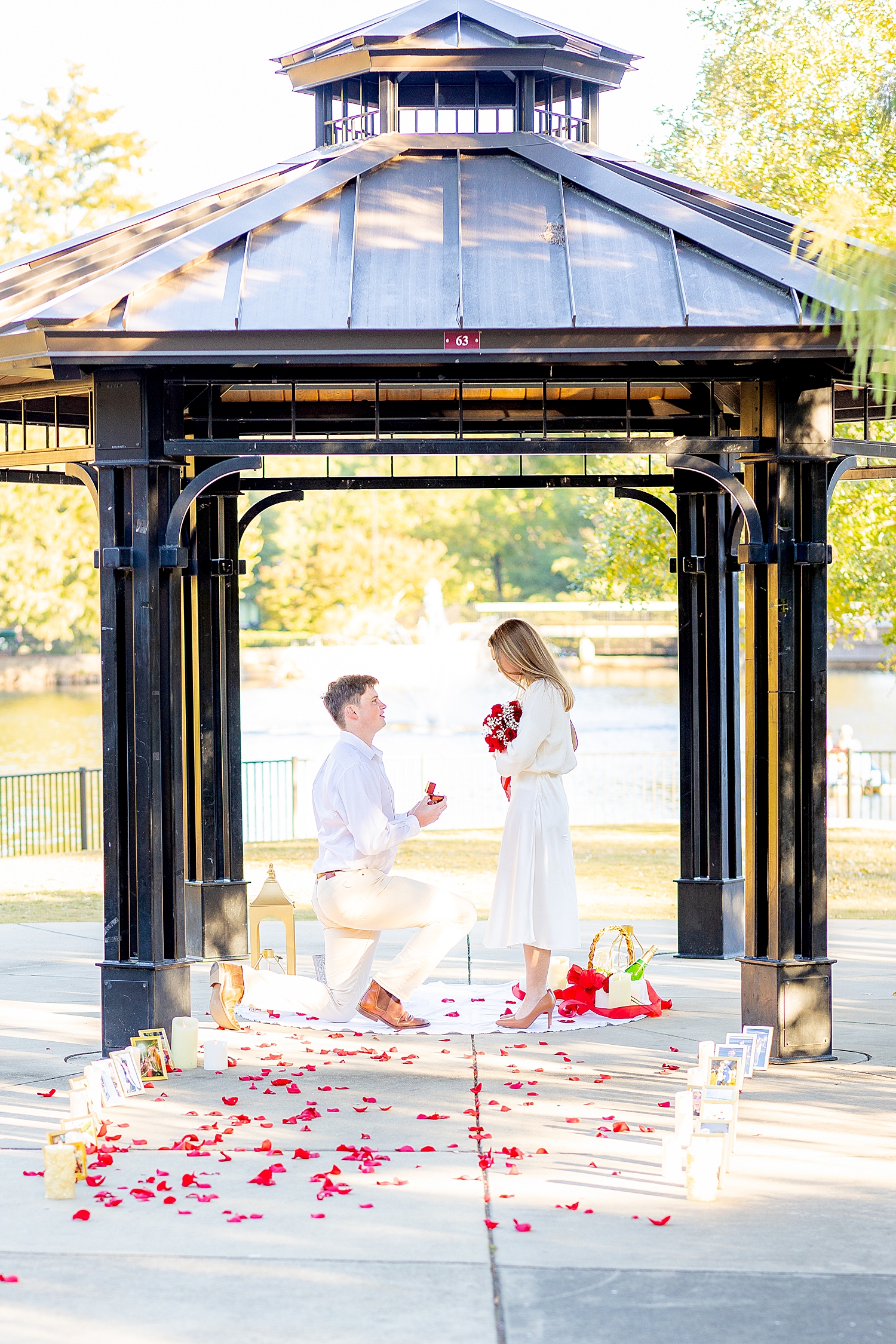 man gets down on one knee to propose to woman