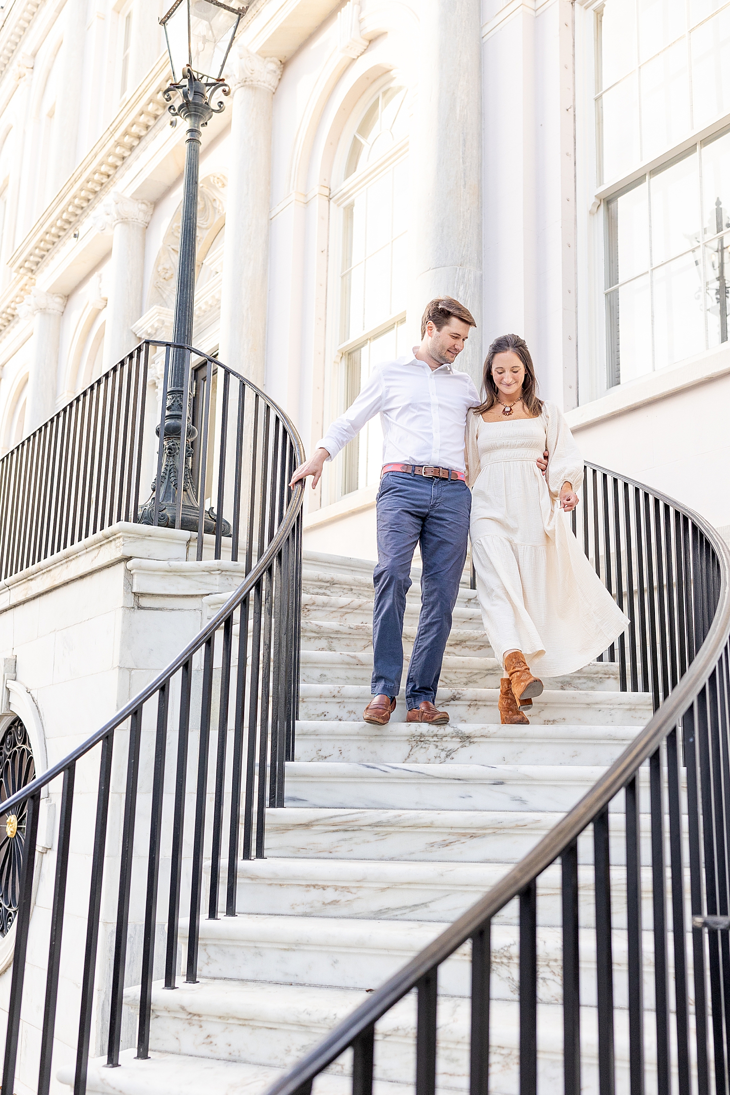 couple descends down spiral stairs