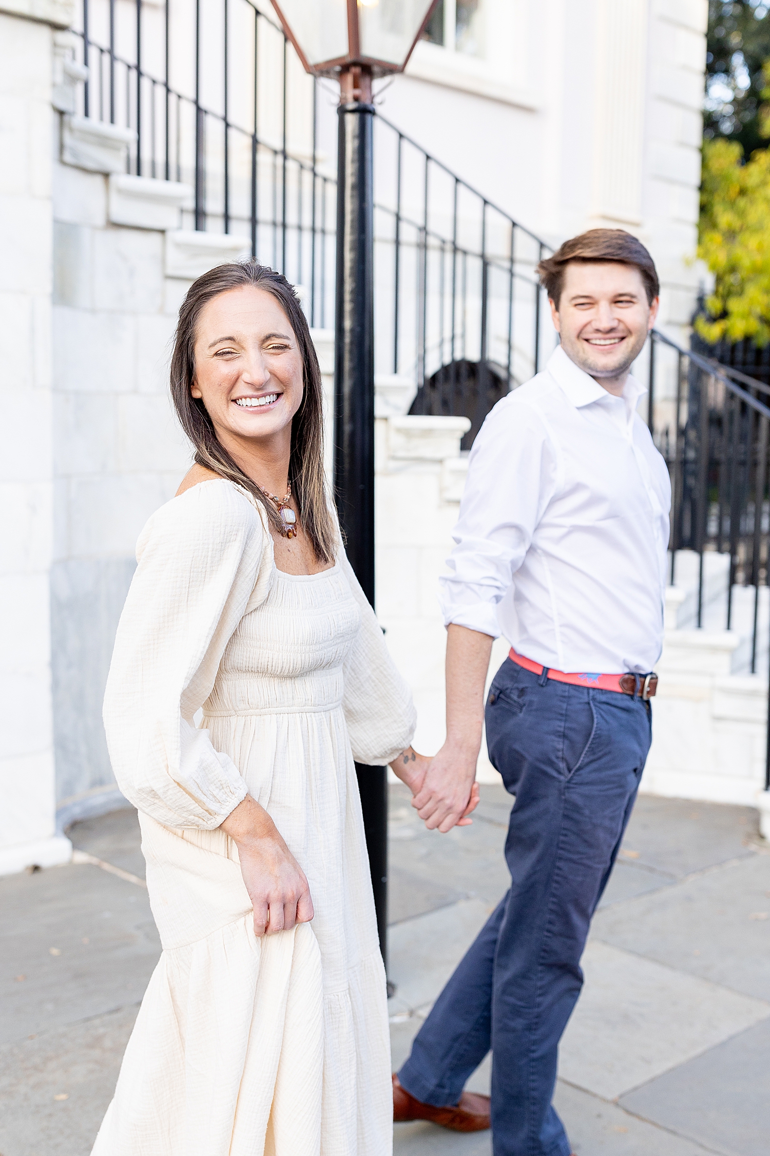 engaged couple hold hands 