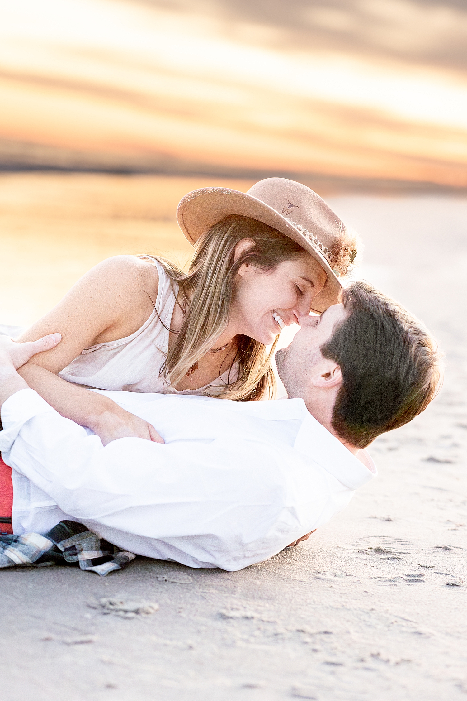 intimate and candid engagement photos of couple on beach