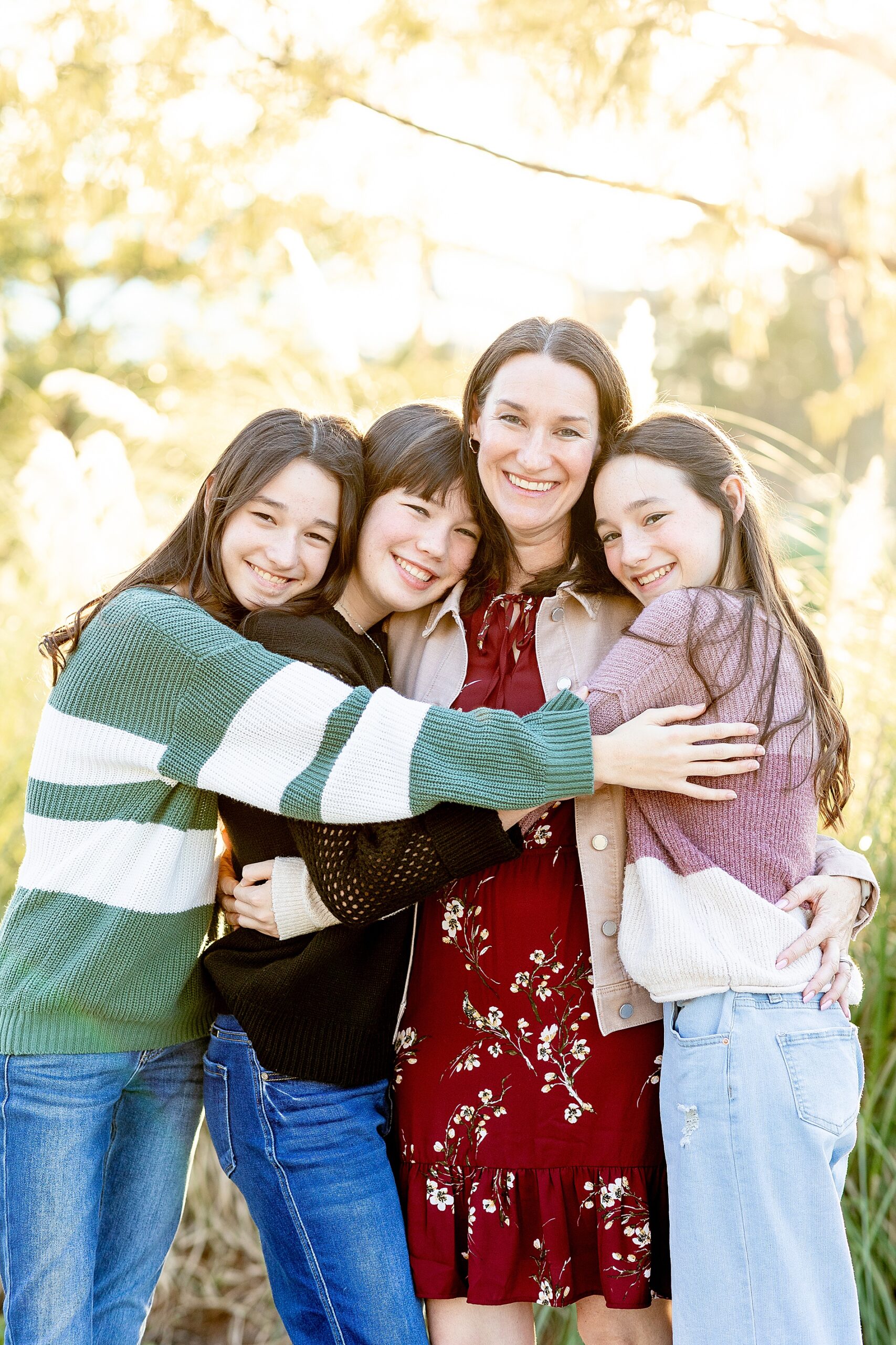 mom hugs her three daughters 