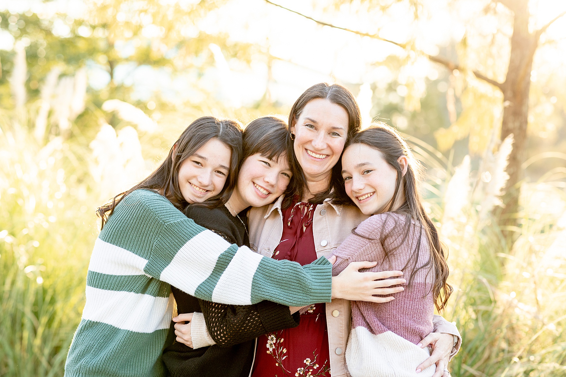 daughters hug their mom 