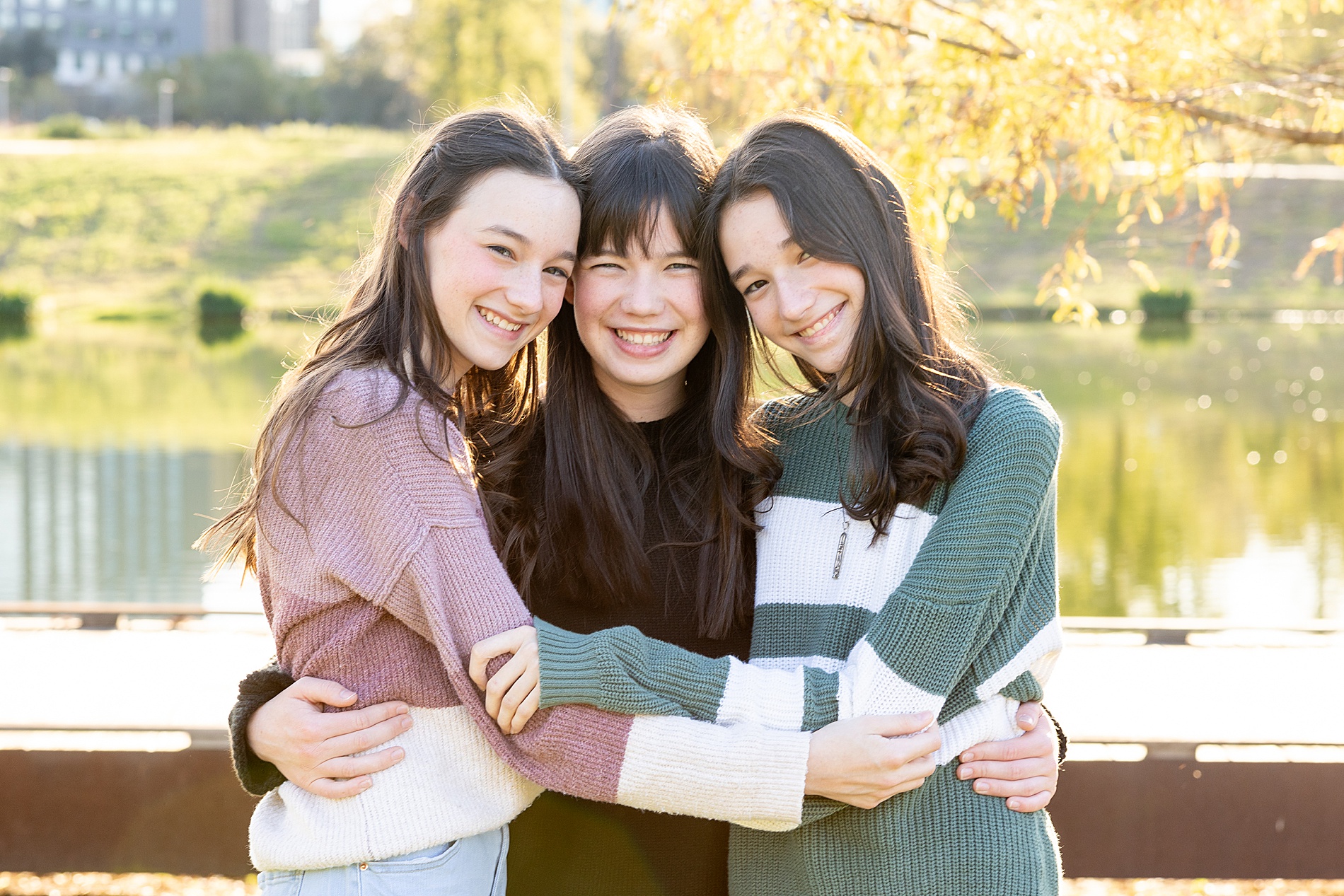 three sisters hug each other