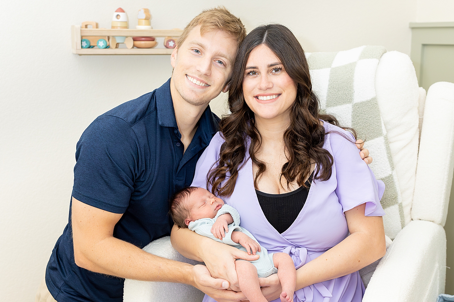 new parents hold newborn 