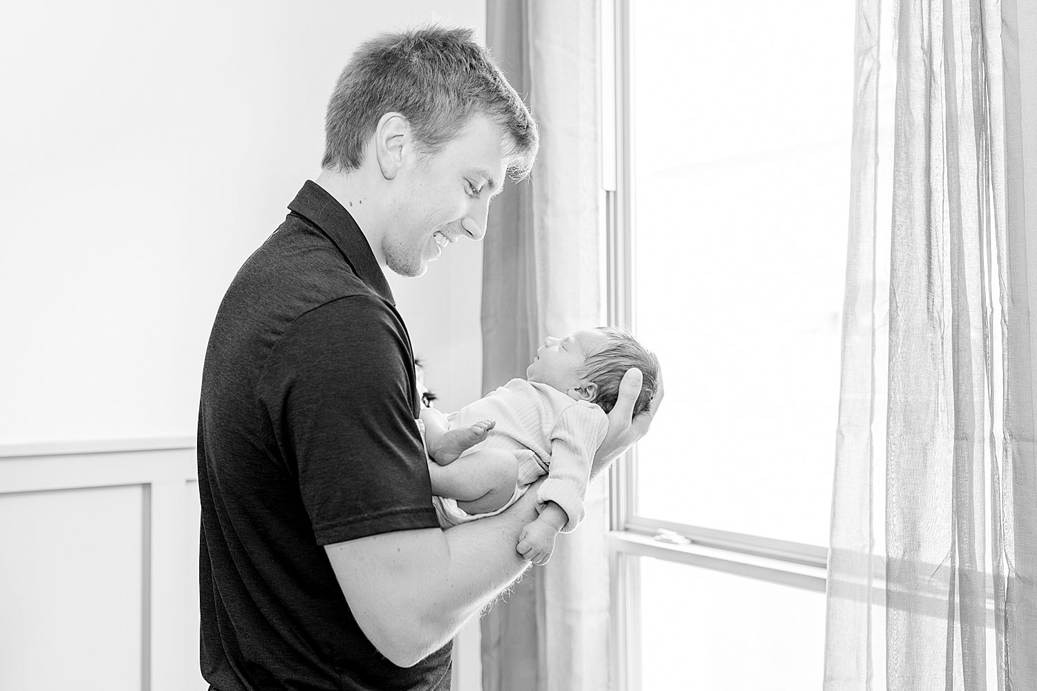 father holds son during Tender In-Home Newborn Session