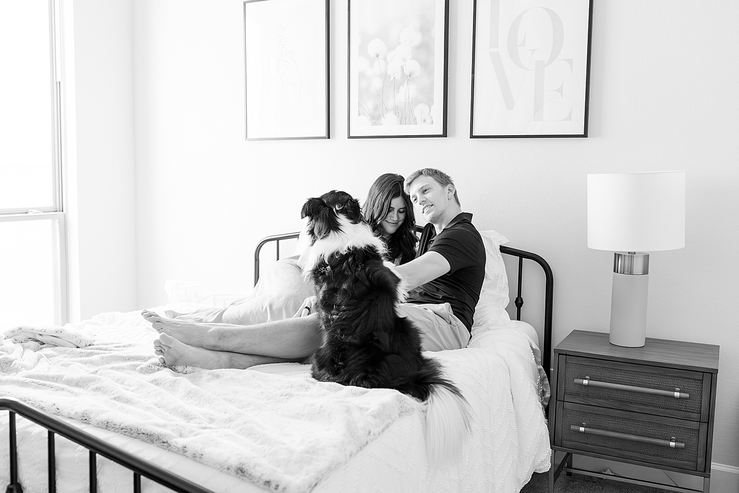 family sits on bed during Tender In-Home Newborn Session