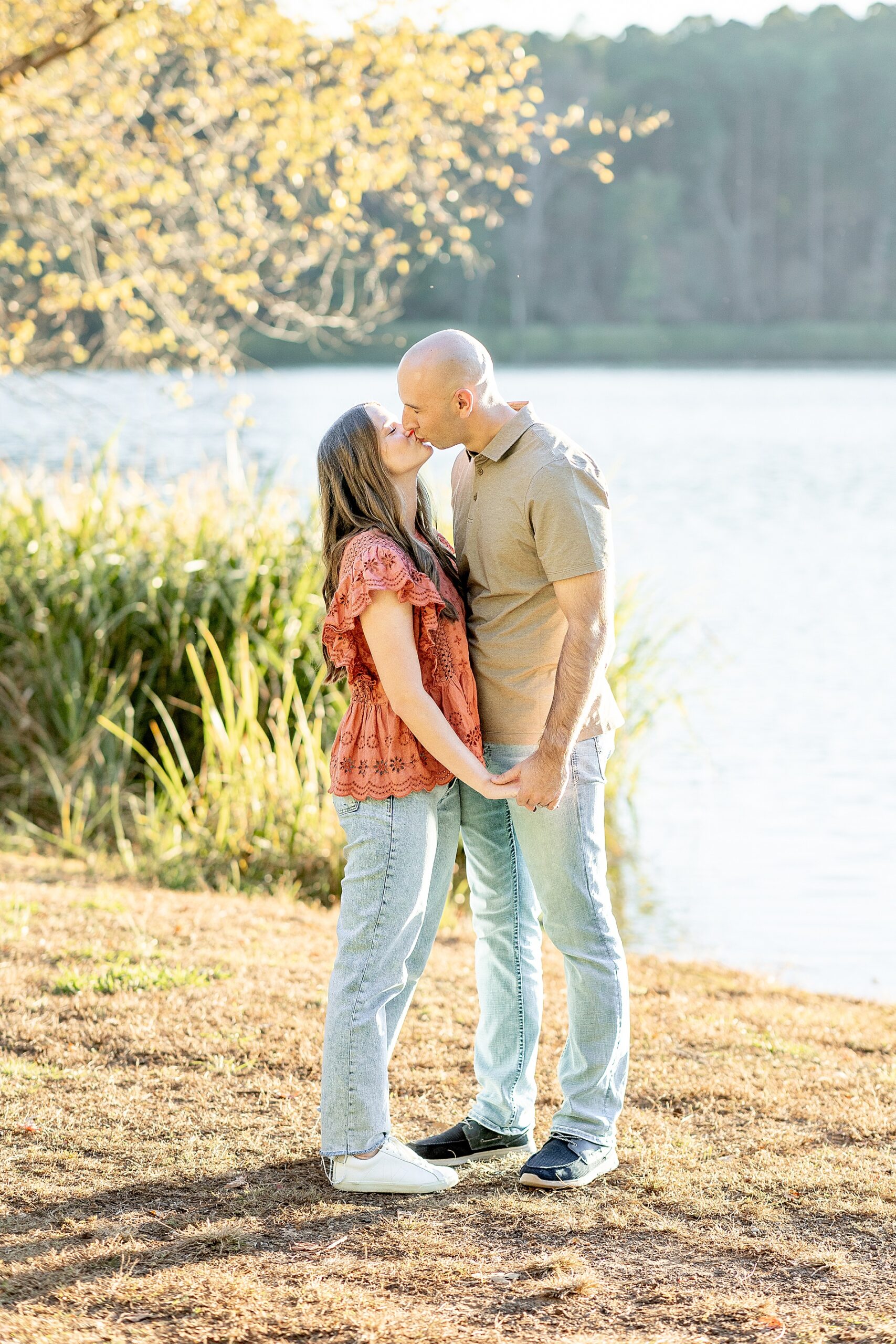 couple kiss by the water at Tyler State Park