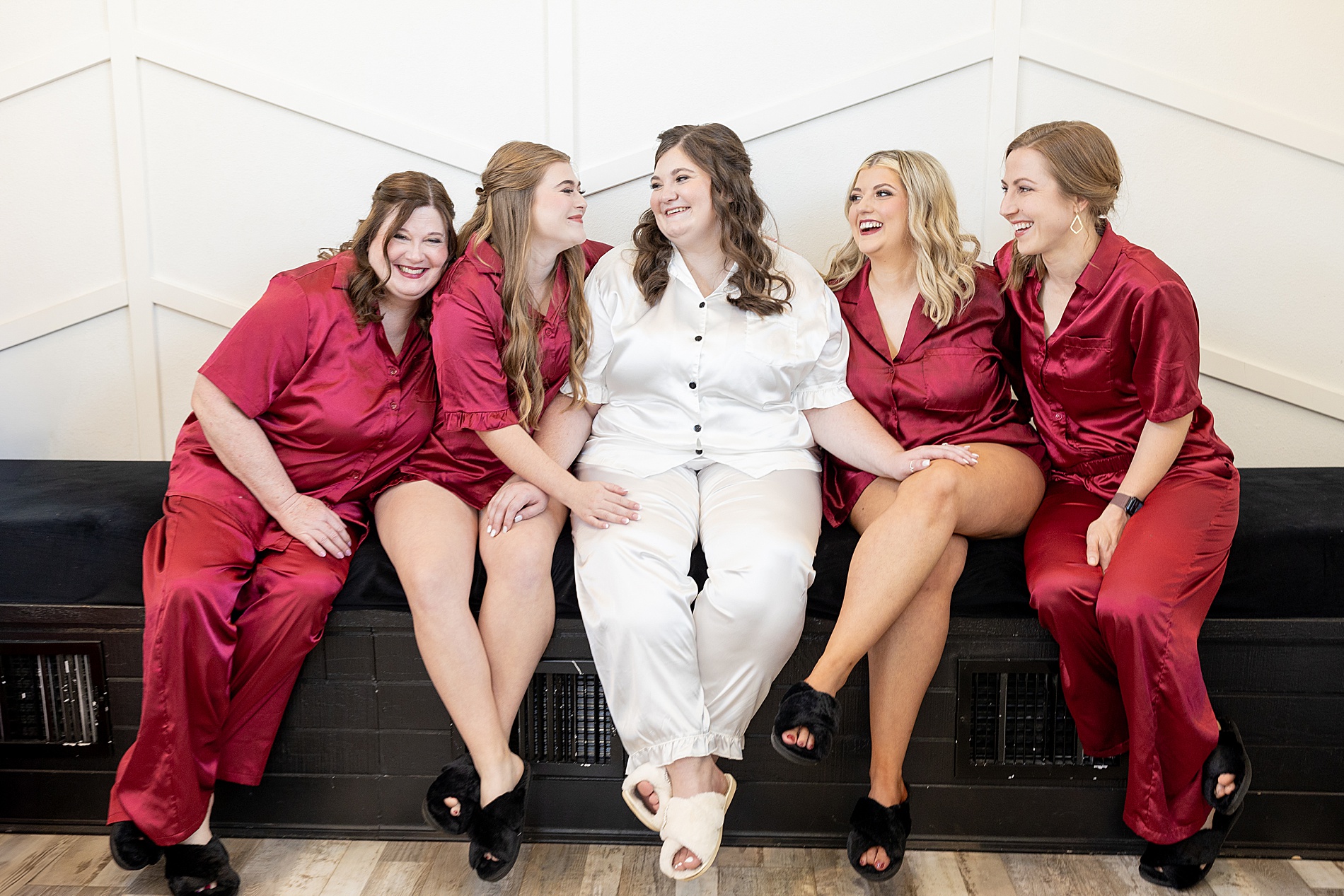 bride getting ready with her bridesmaids in matching pjs