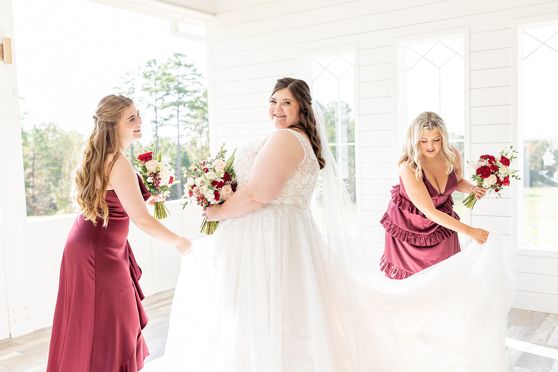 bridesmaids help bride with dress