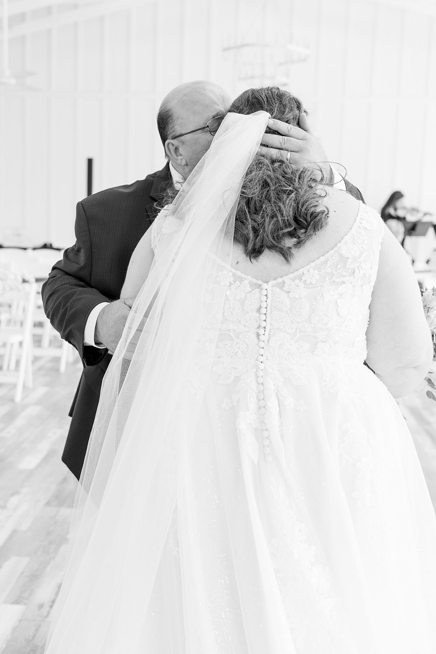 bride hugs her dad during first look