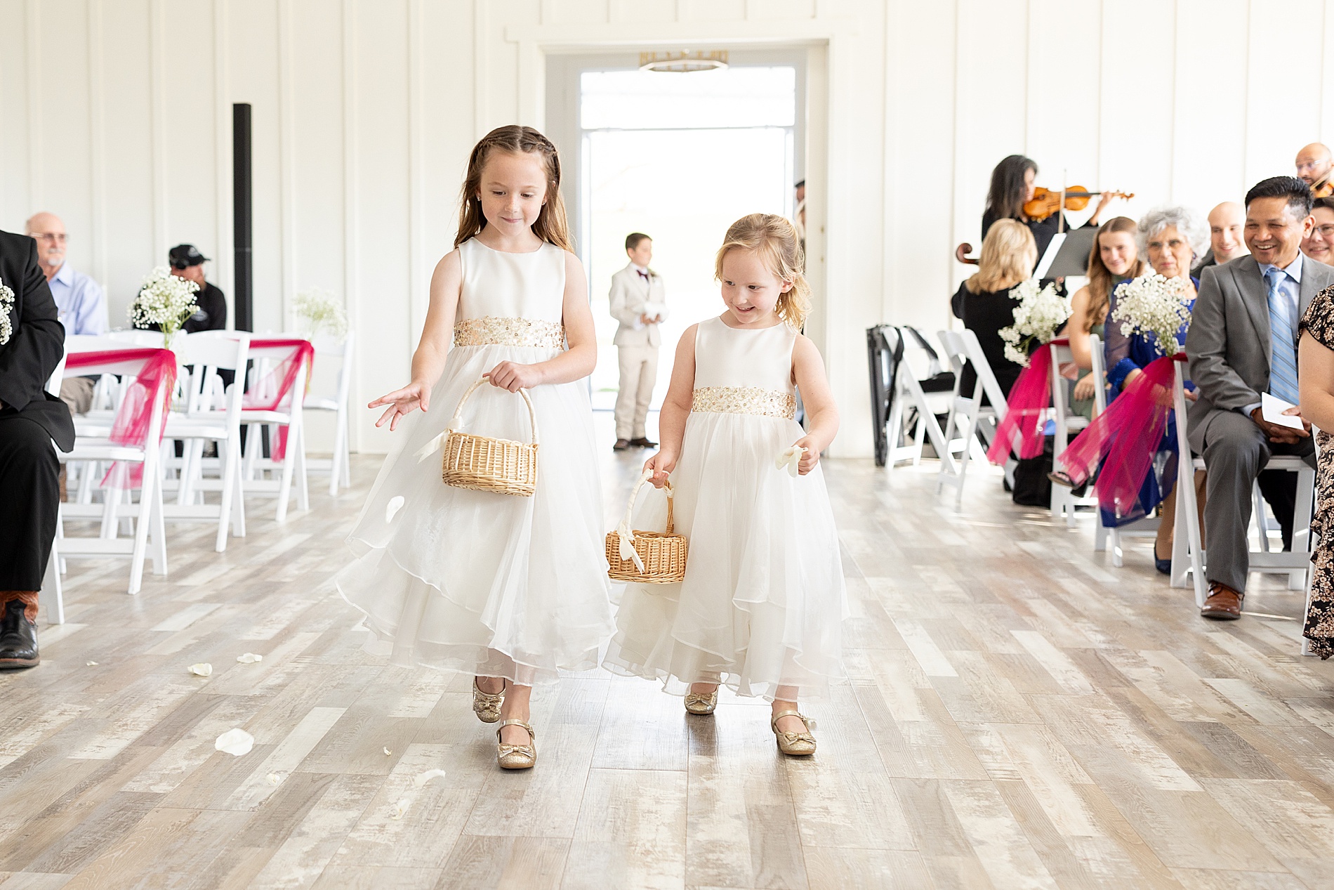 flower girls walk down the aisle 