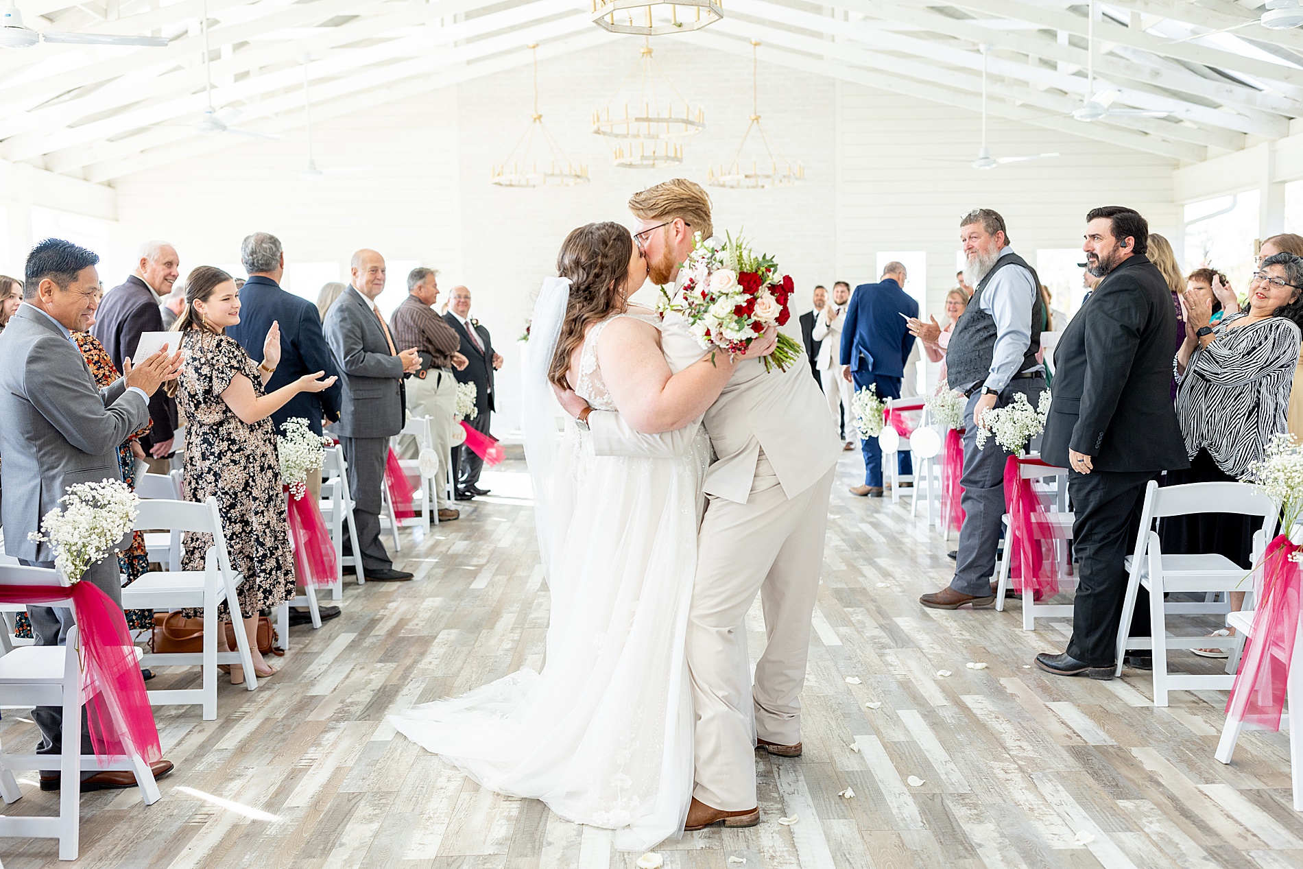 newlyweds kiss as they exit ceremony in East Texas