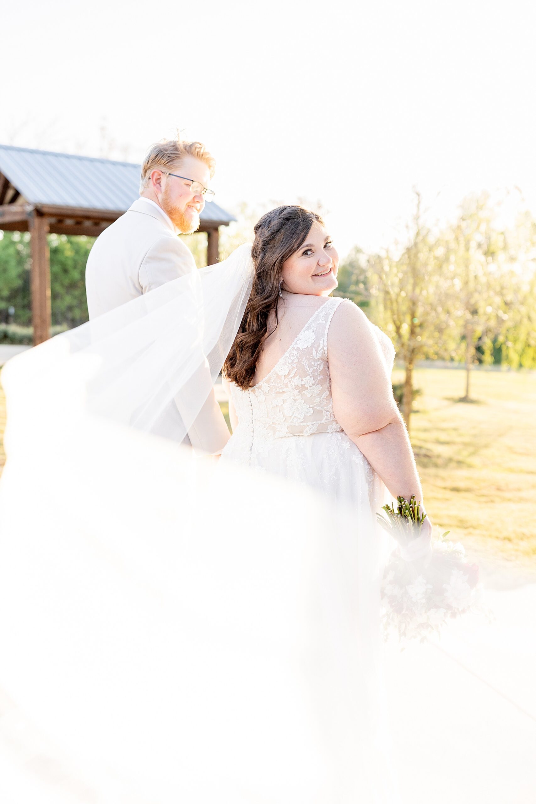 newlyweds walk together during sunset wedding photos