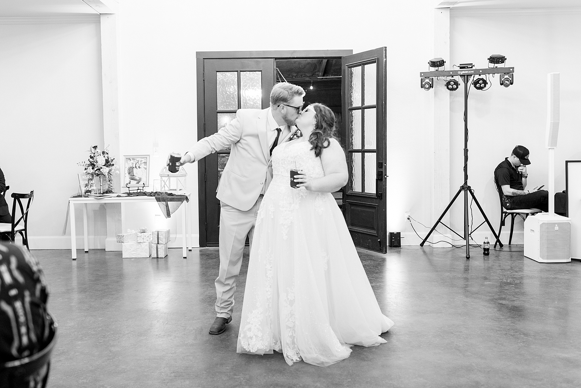 couple kiss as they enter reception