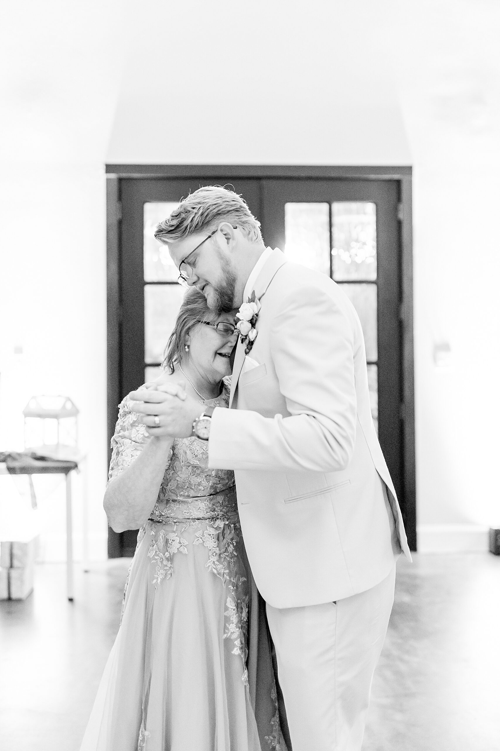 candid moment between mother and son at Classic East Texas Wedding