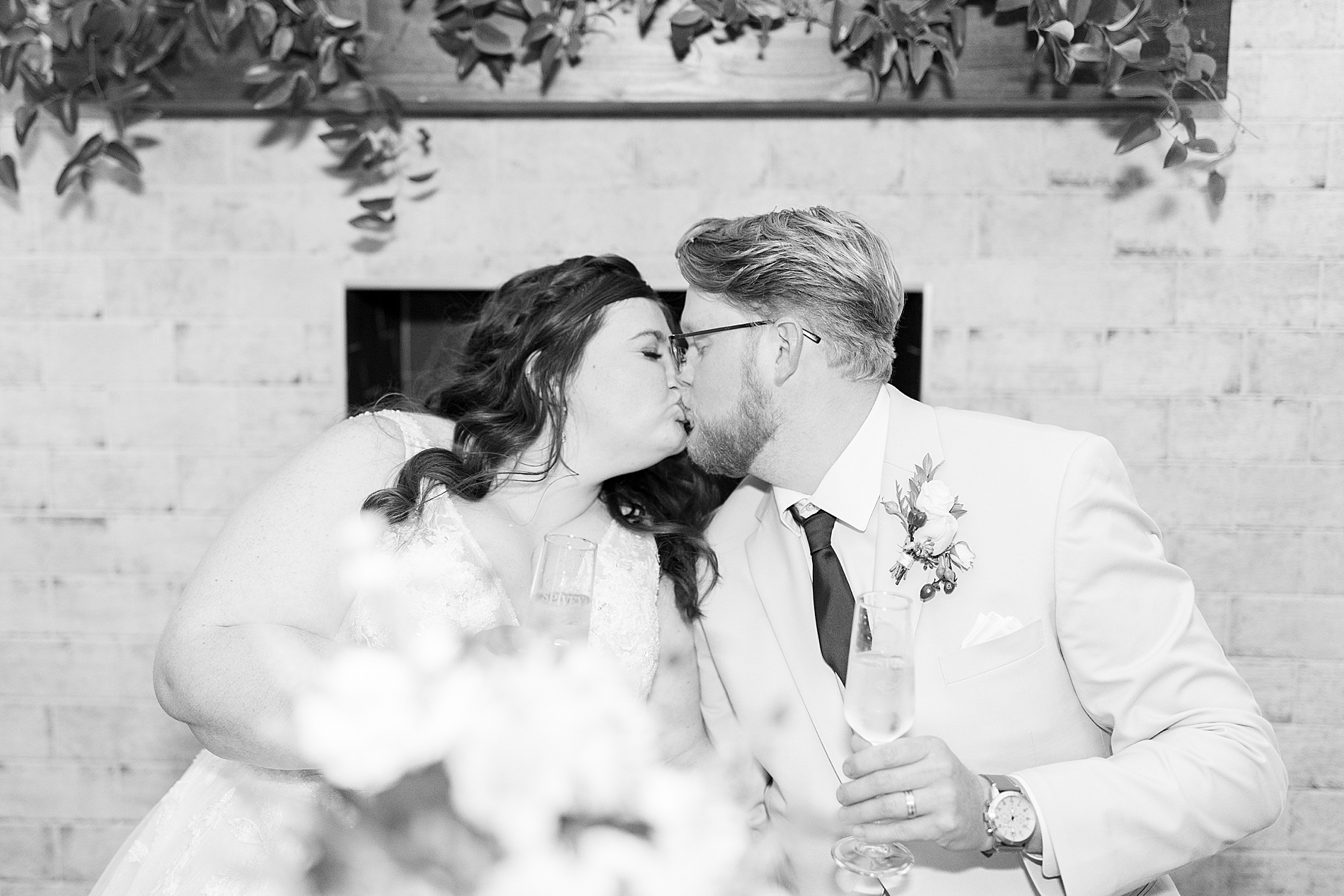 newlyweds kiss during wedding reception 