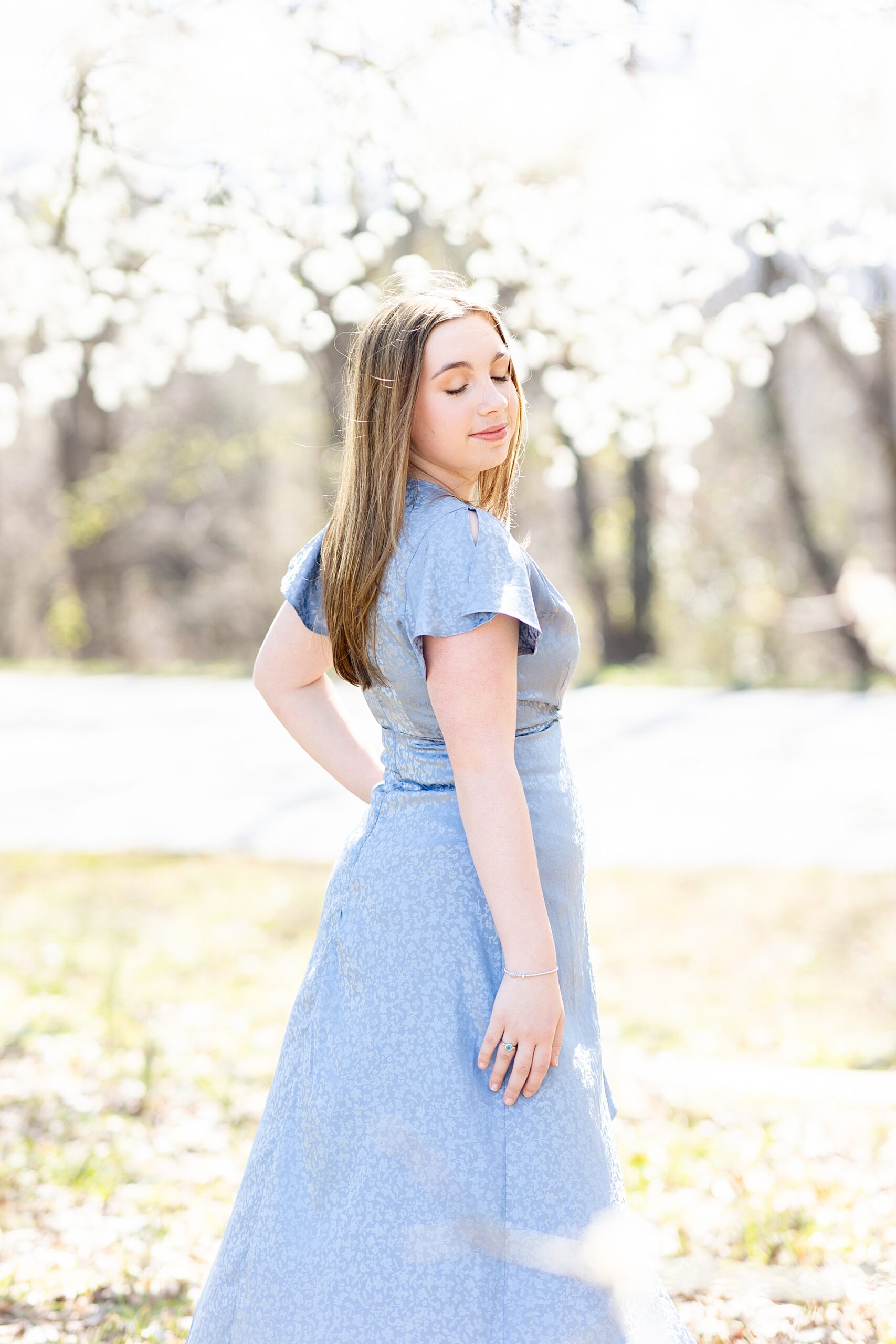 Senior girl in blue dress during spring grad session