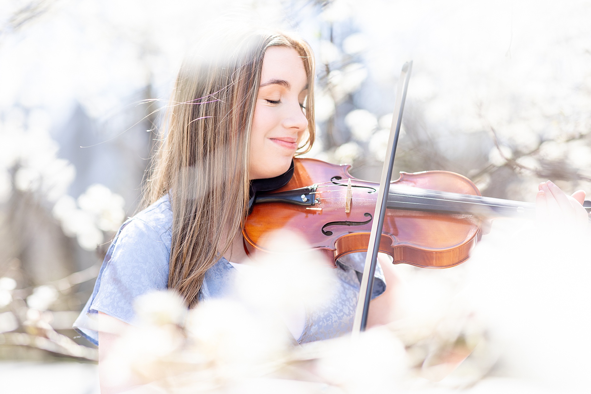 Dreamy Spring Senior Session with senior playing the violin at BridgeWay Station