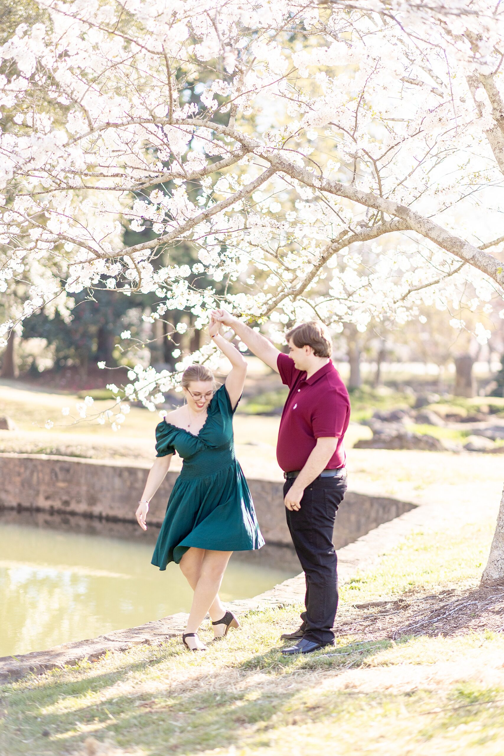 couple dance under blooming tree in springtime