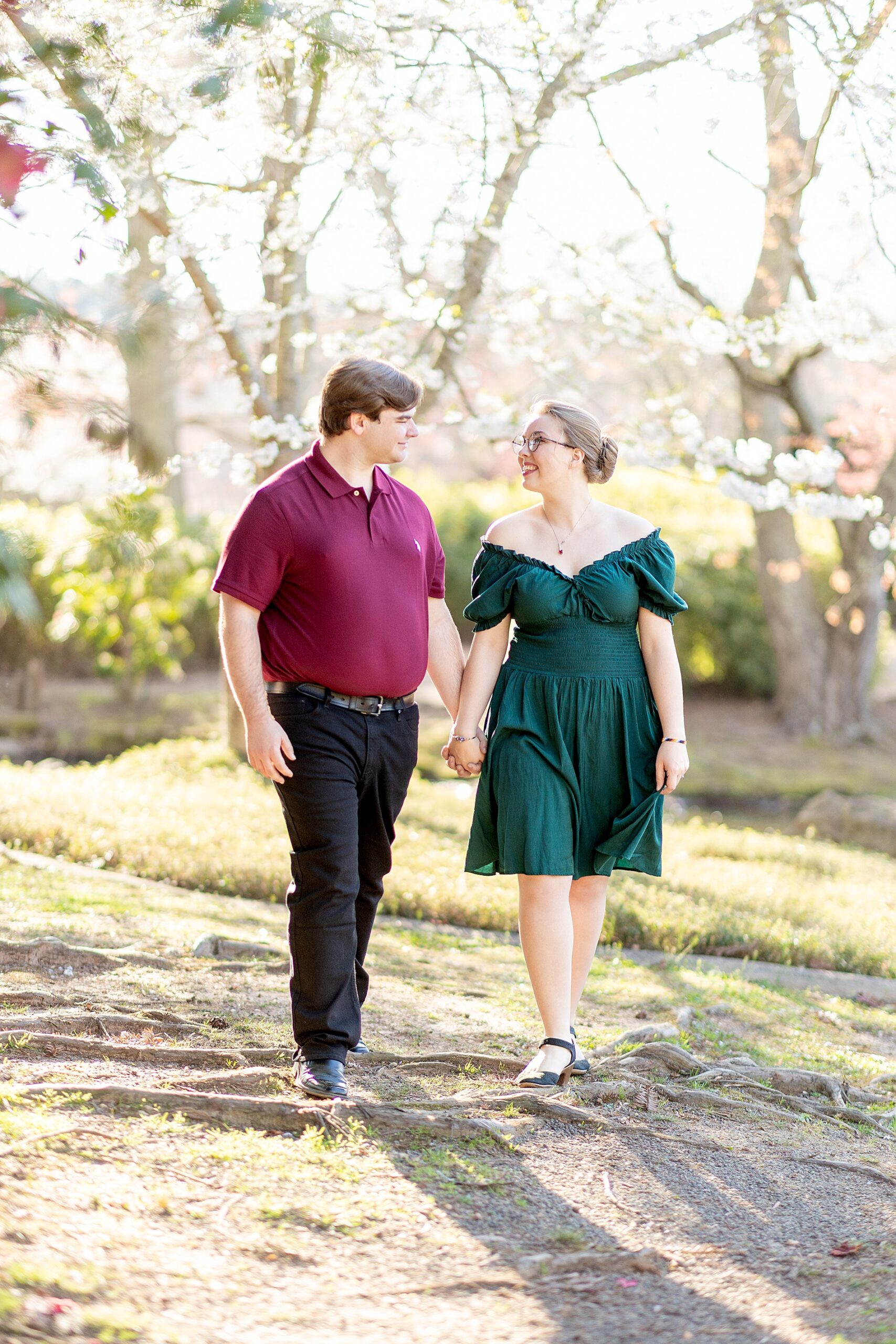 couple walk the grounds of Furman University during engagement session