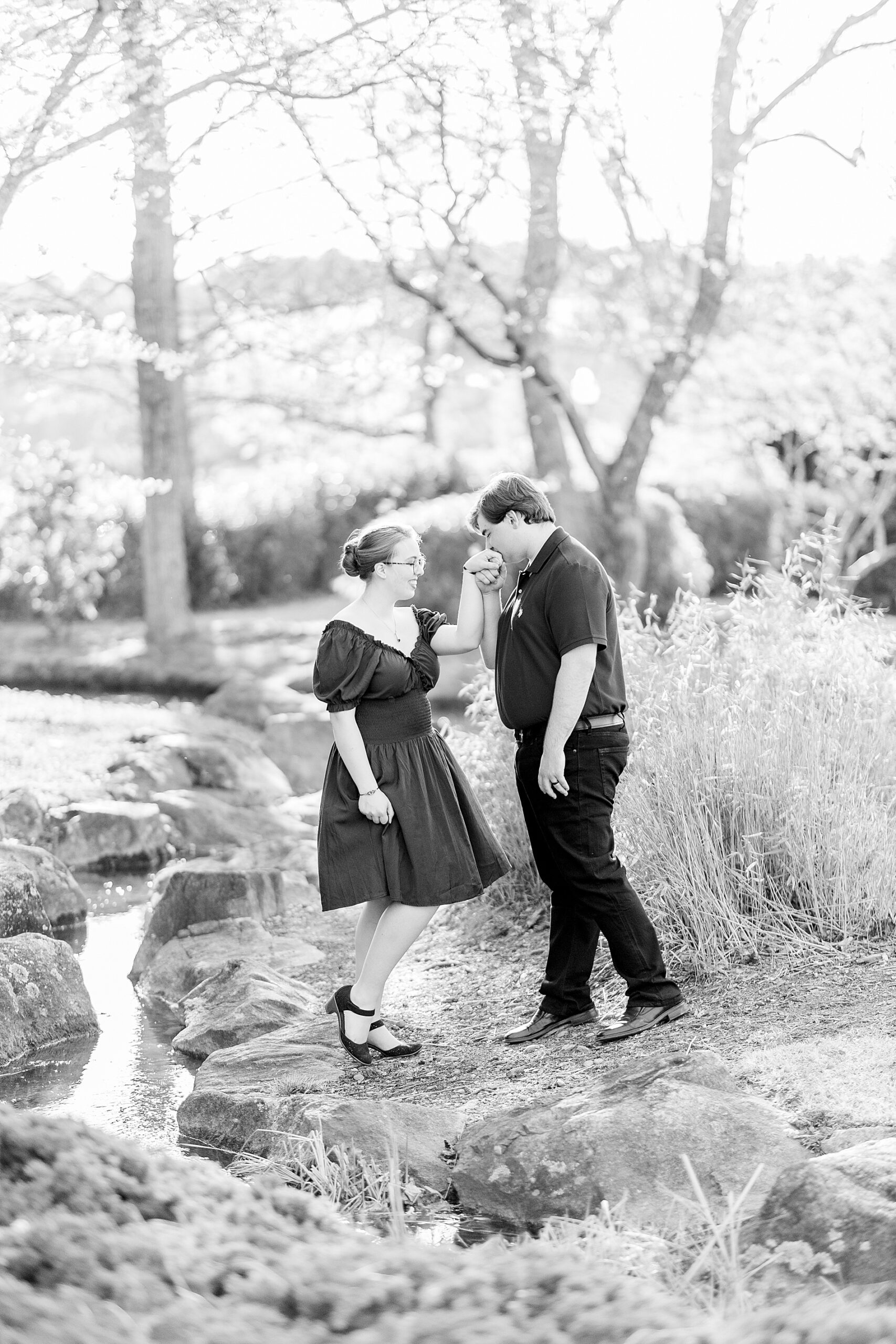 man kisses fiancé's hand
