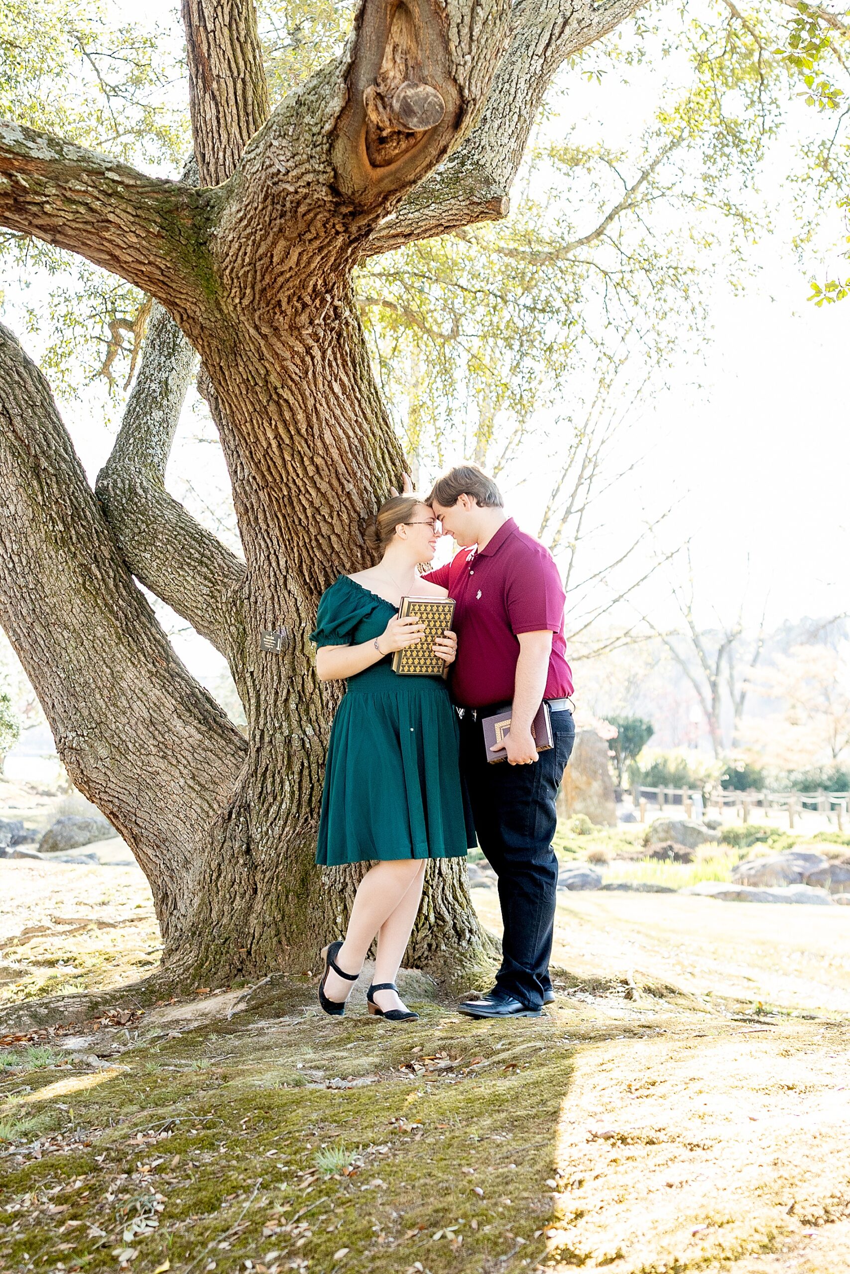 couple lean against tree