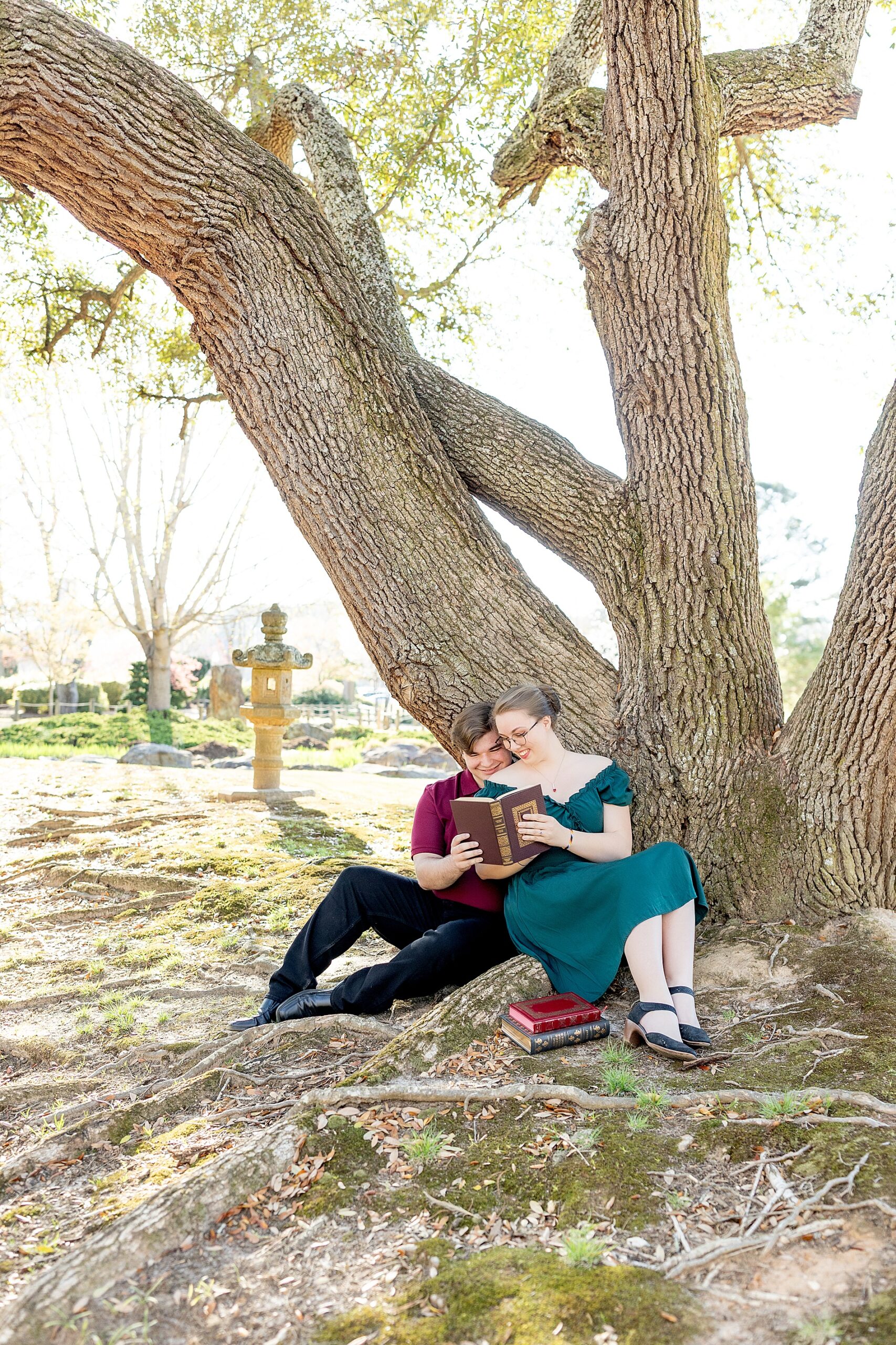 couple sit under oak tree and read classic books