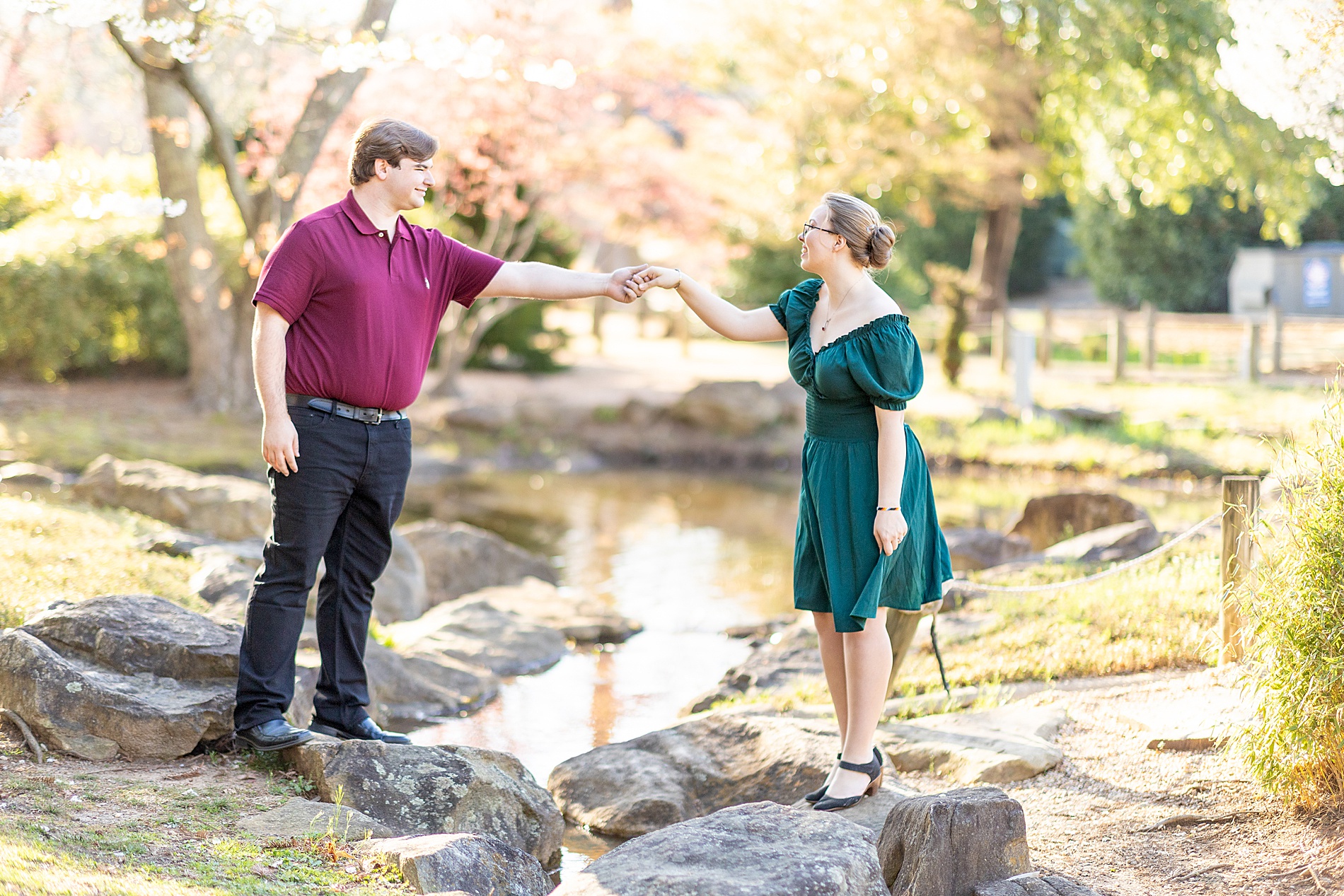 guy helps woman cross over water