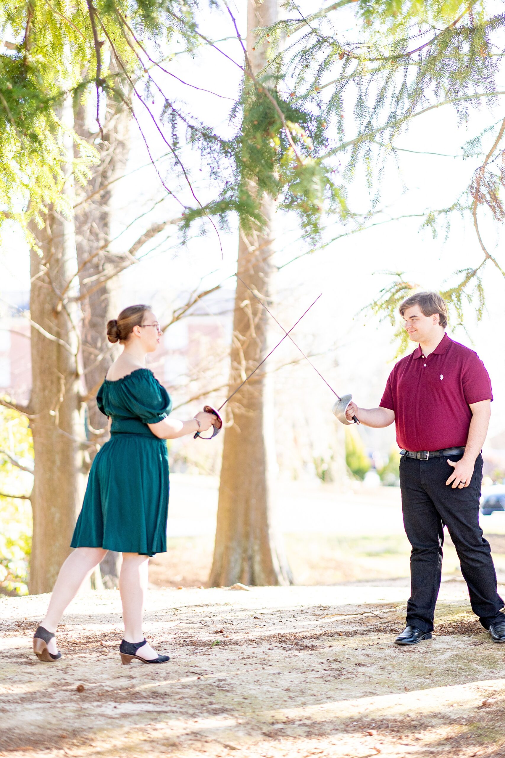 couple have sword fight during engagement session