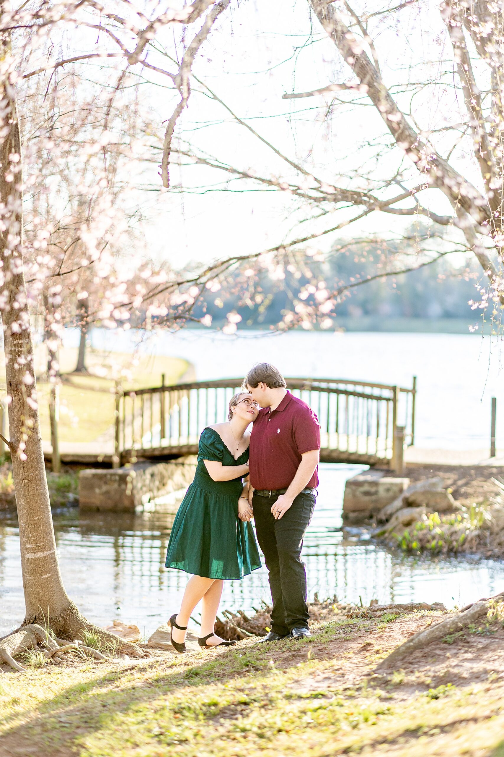 romantic engagement photos of couple by water