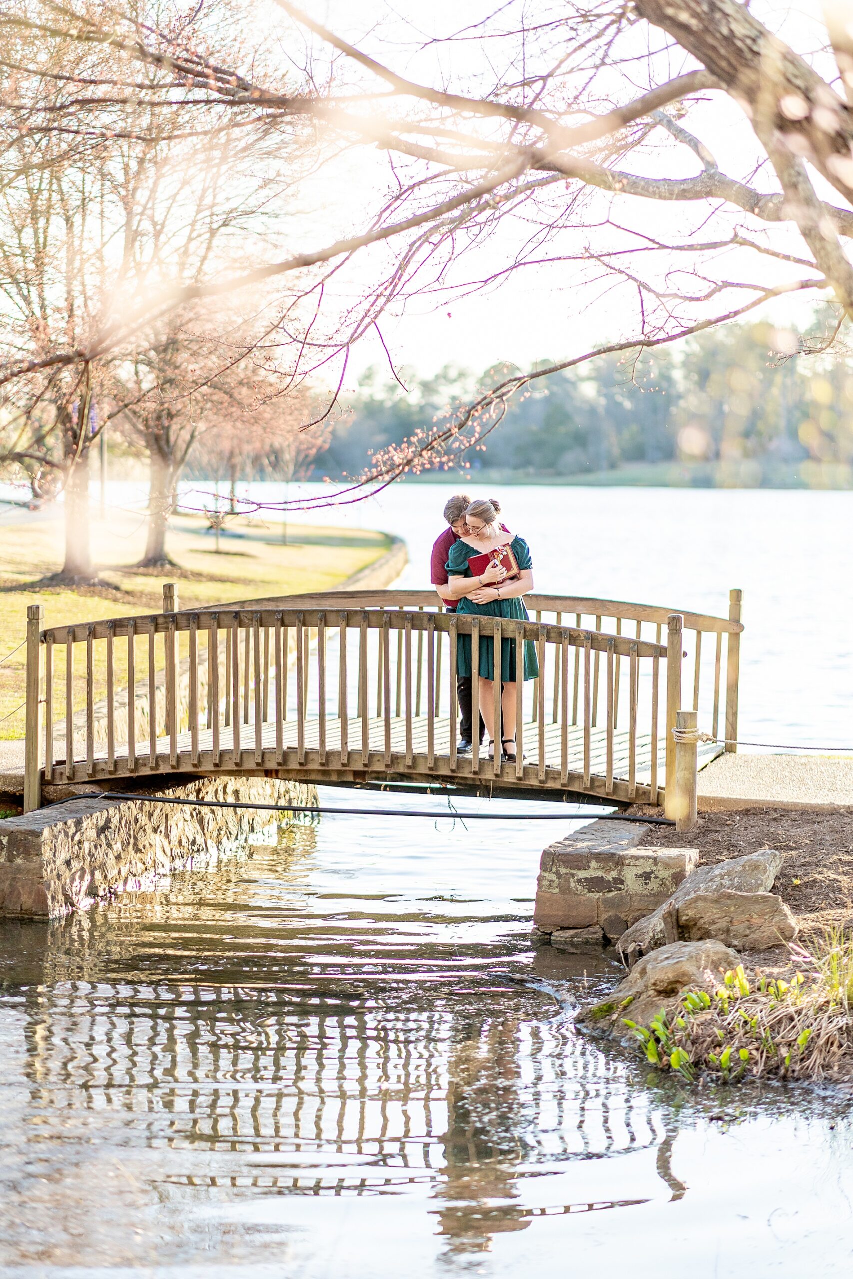 couple on bridge during romantic spring engagement