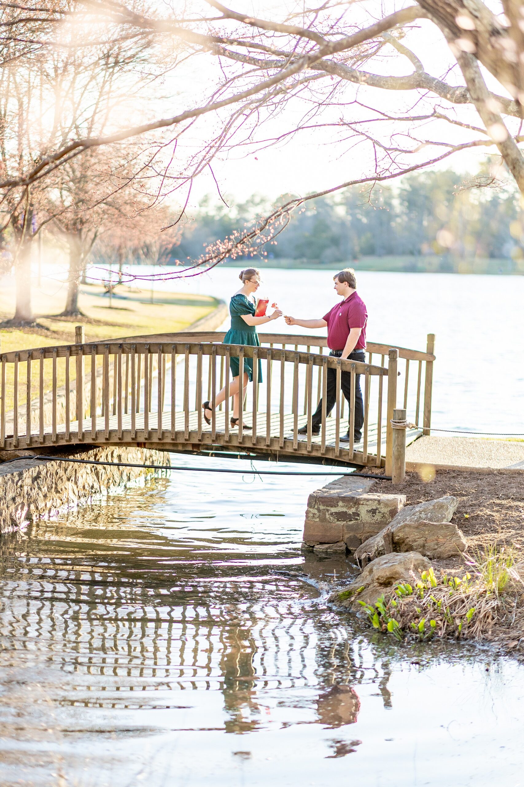couple on bridge over the water at Furman University