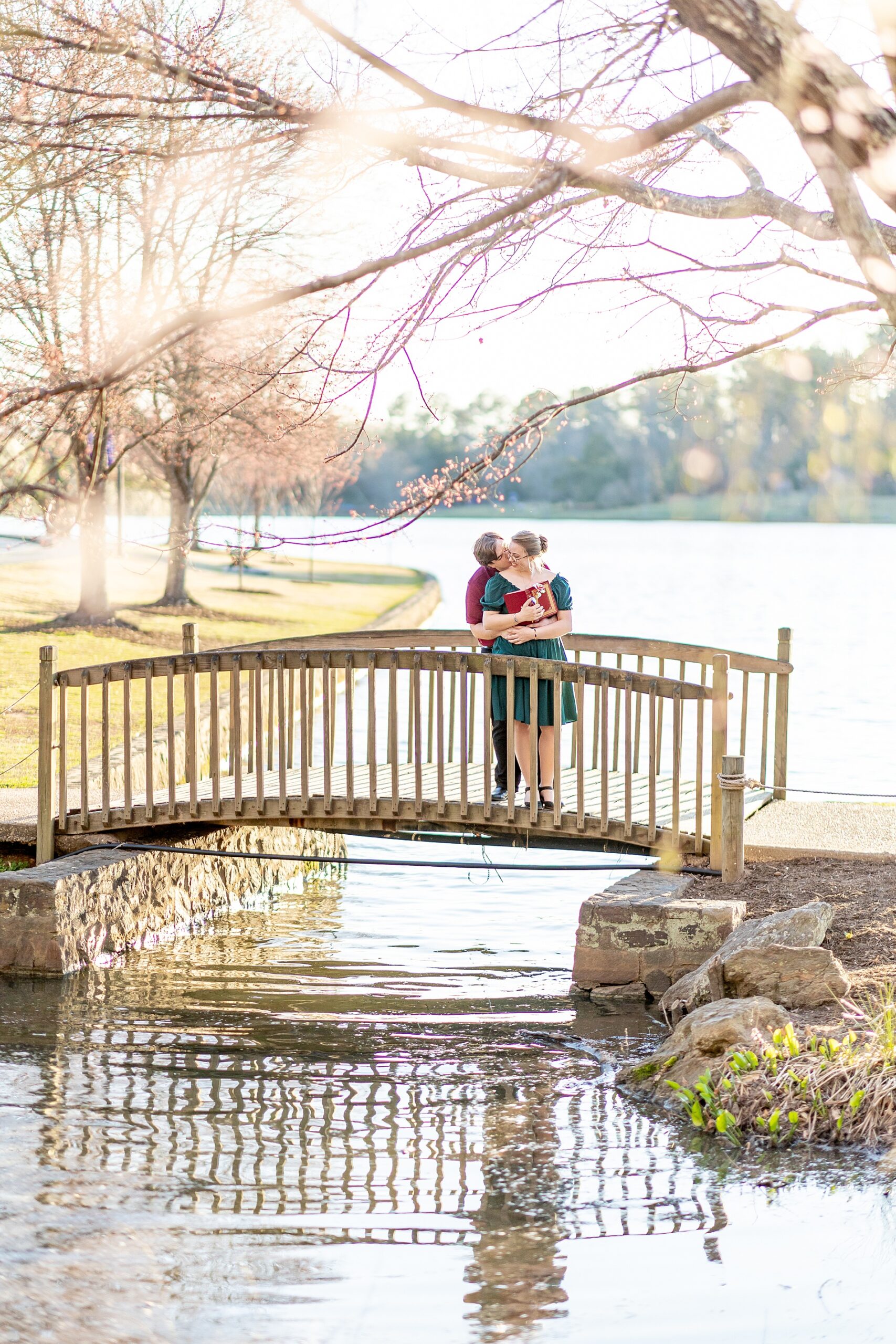 couple hug on bridge from Furman University Engagement Session