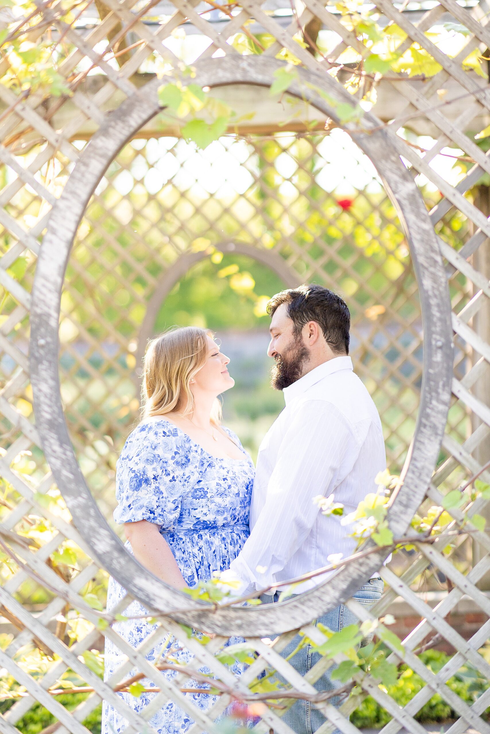 couple by pergola in gardens