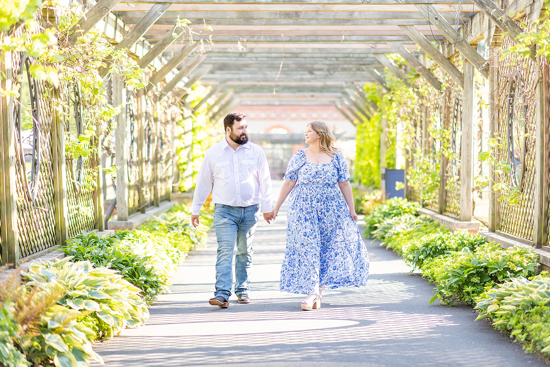 engaged couple walk together holding hands